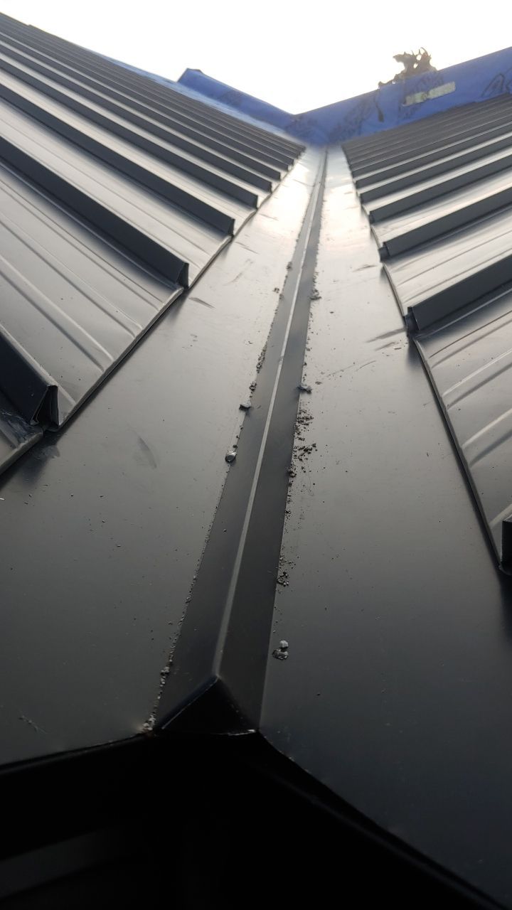 Commercial Roofing Installation using 12" Prolok metal and hidden gutters! by Top Notch Roofing Inc