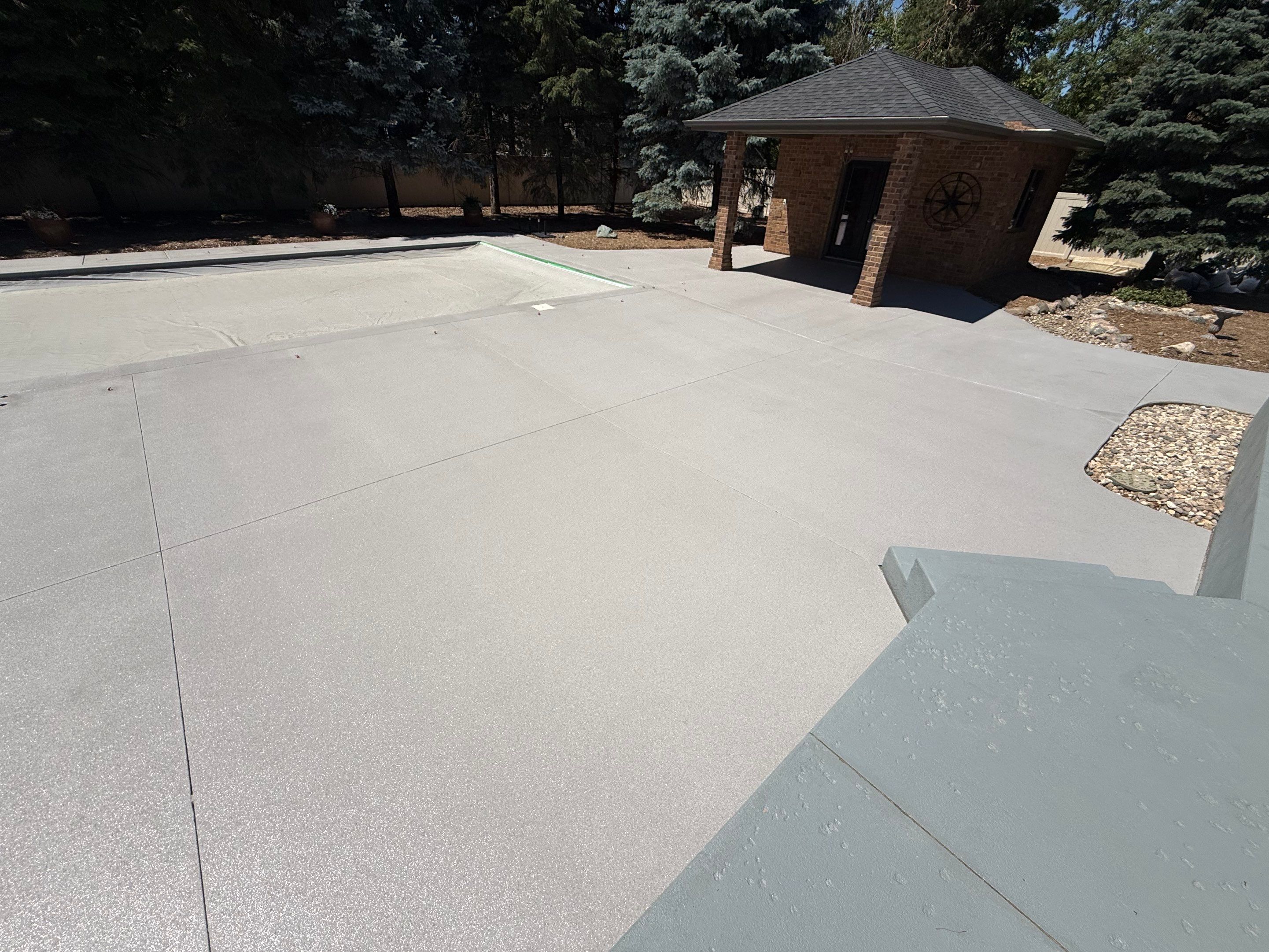 Decorative Concrete Pool Deck and Patio Resurfacing in Sioux Falls by Select Painting, Coatings & Garage Cabinets