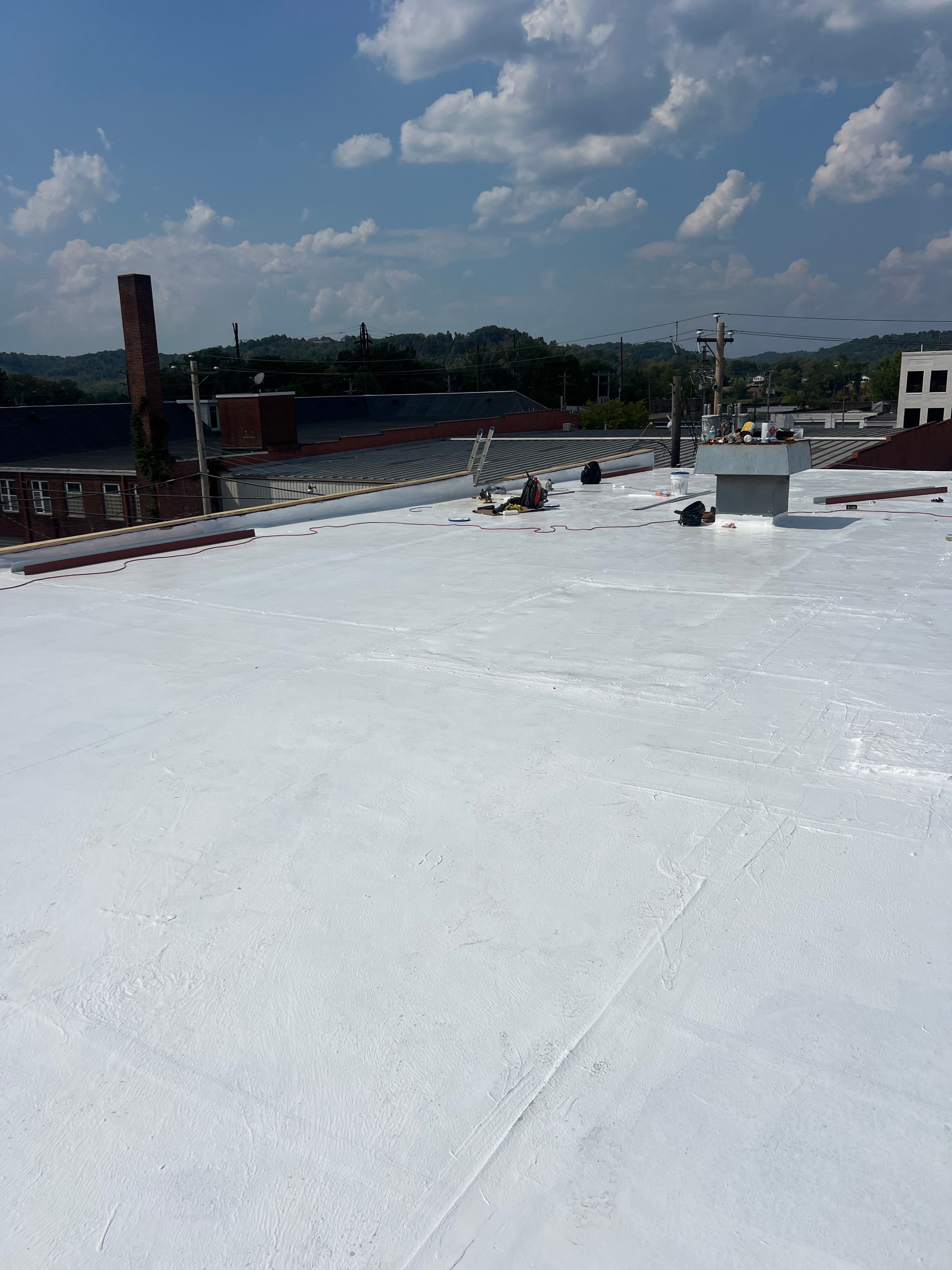 Commercial Roofing Installation using smartcoat Roof coating by Fahey Roofing + Contracting