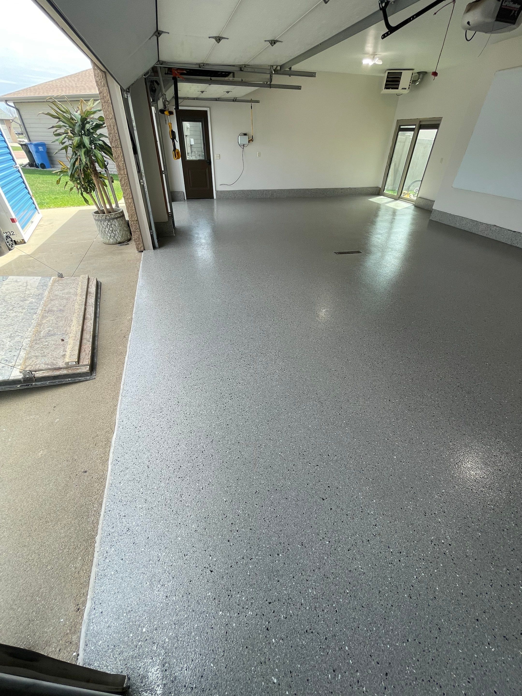 Residential Garage Floor Coating with Grey Speckled Epoxy Finish by Select Painting, Coatings & Garage Cabinets