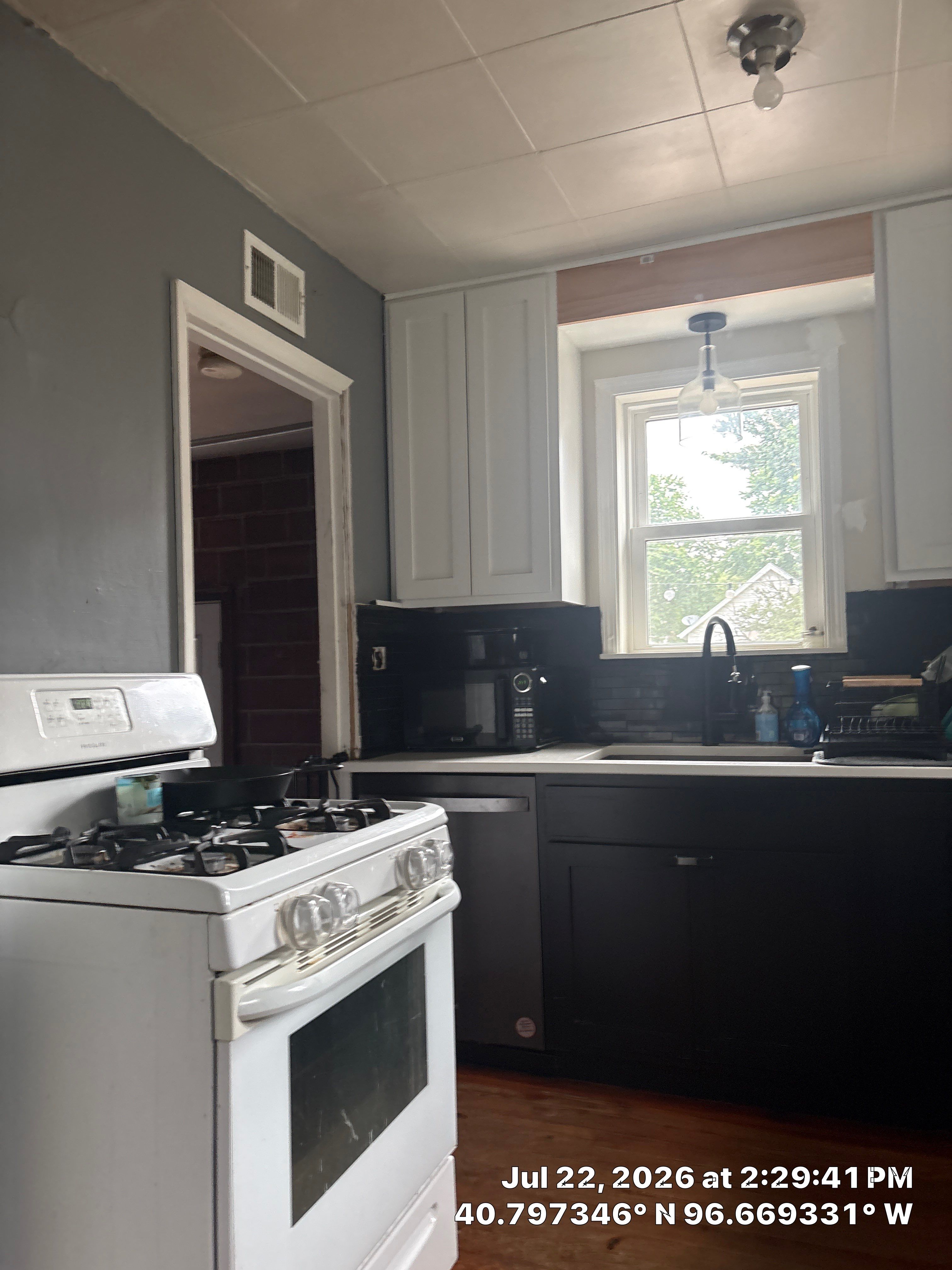 Modern Kitchen Renovation with Two-Tone Cabinetry and Quartz Countertops by CompanyCam Sales Demo
