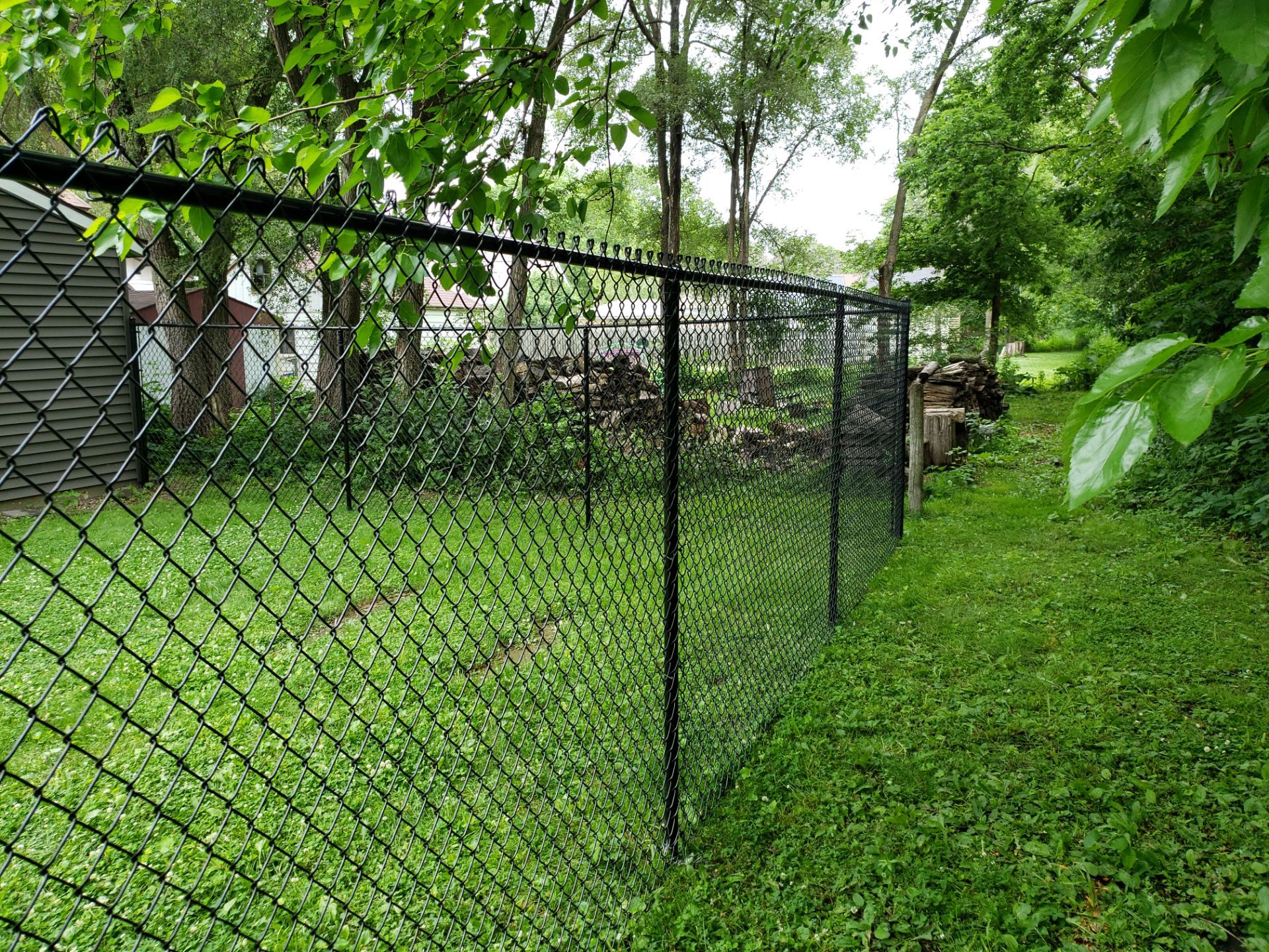 Black Vinyl Chain Link Fence Installation in Charles City by Perfect Picket Fence and Stain