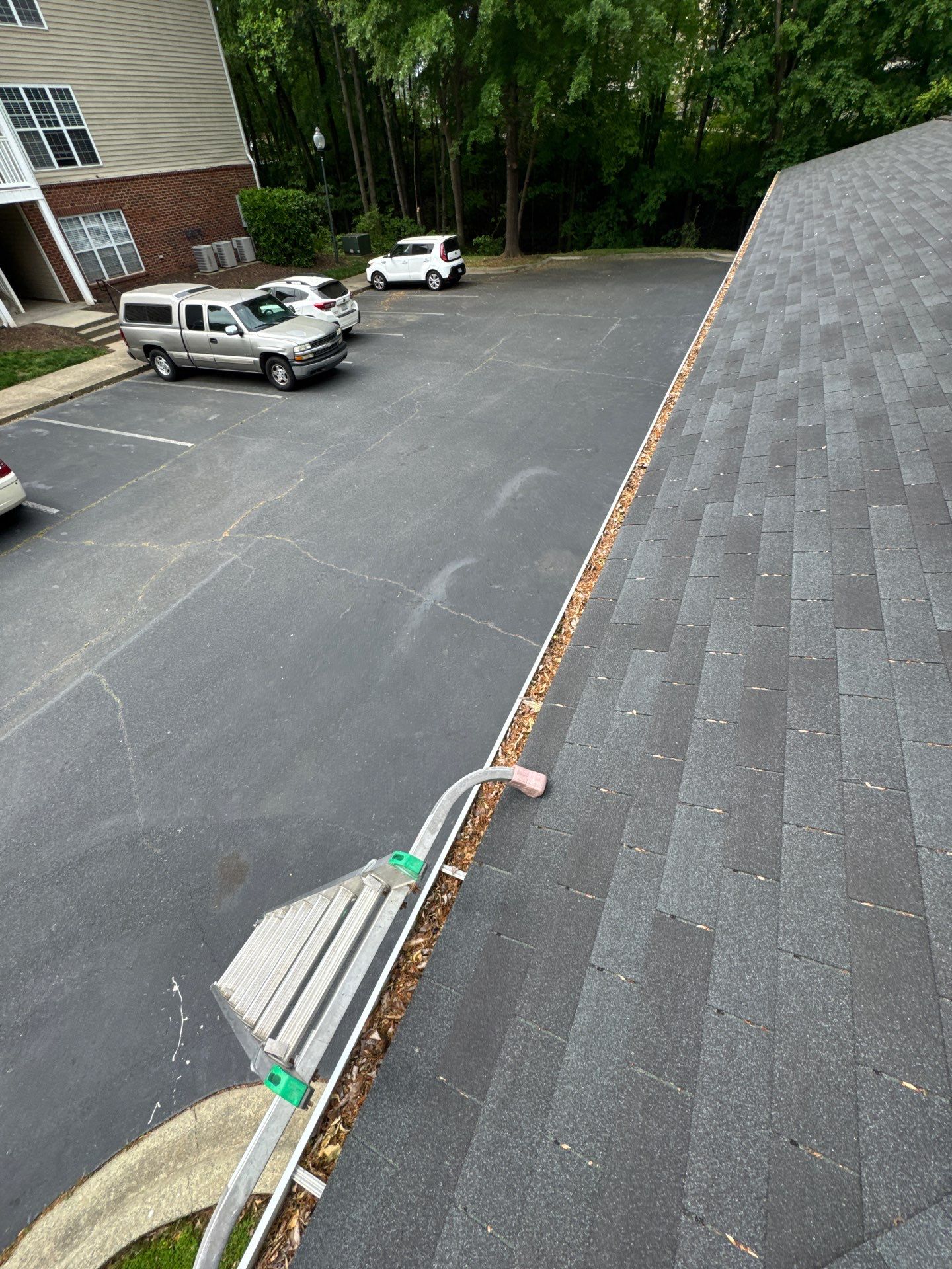 Commercial gutter cleaning Burlington / Mebane before photo with filled gutters
