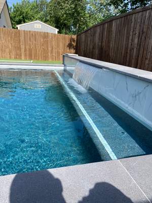 Modern Geometric Pool with Tanning Ledge and Turf