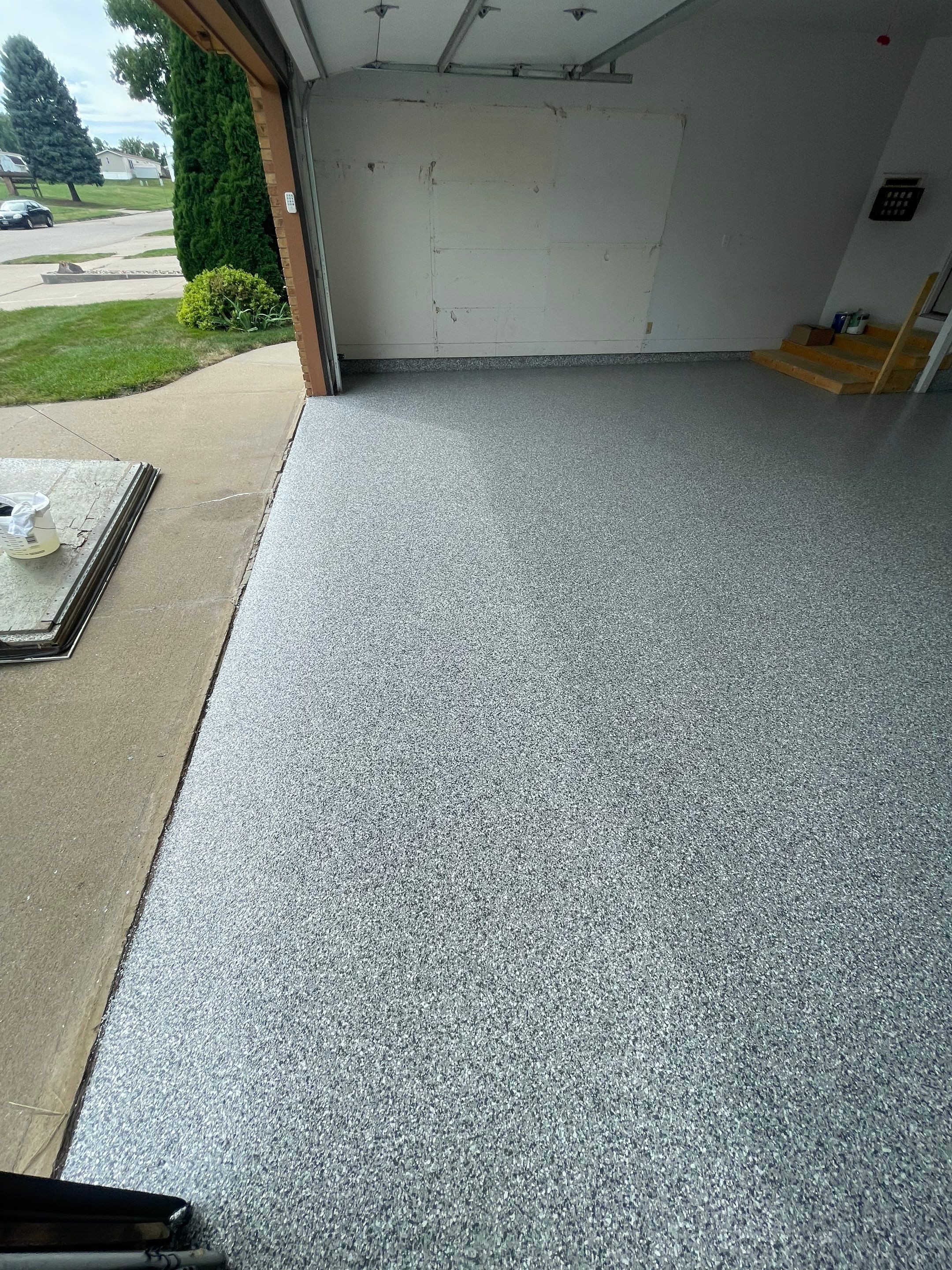 Grey Speckled Concrete Coating for Residential Garage in Yankton by Select Painting, Coatings & Garage Cabinets