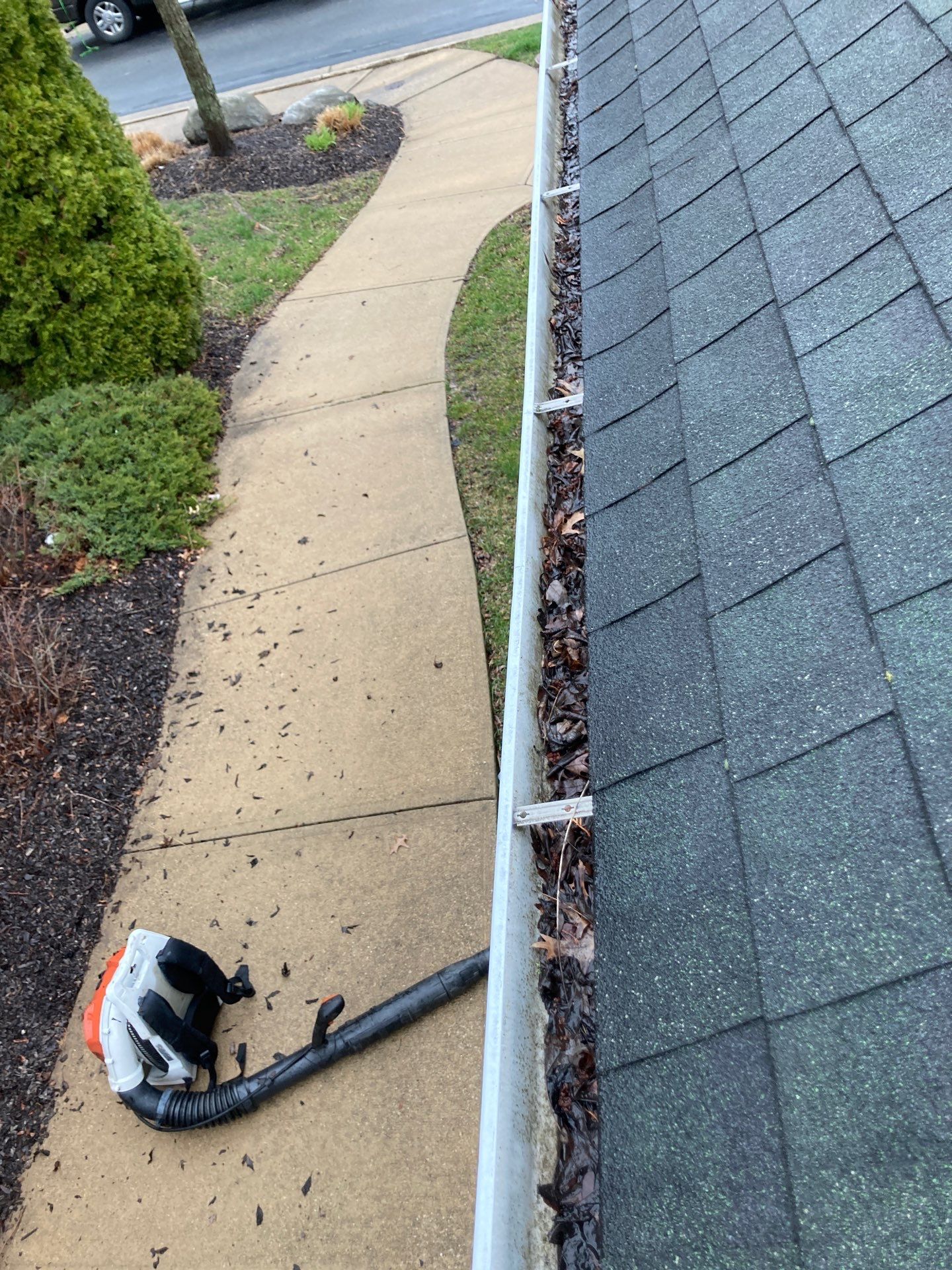 Commercial gutter cleaning Cleveland, before photo with filled gutters