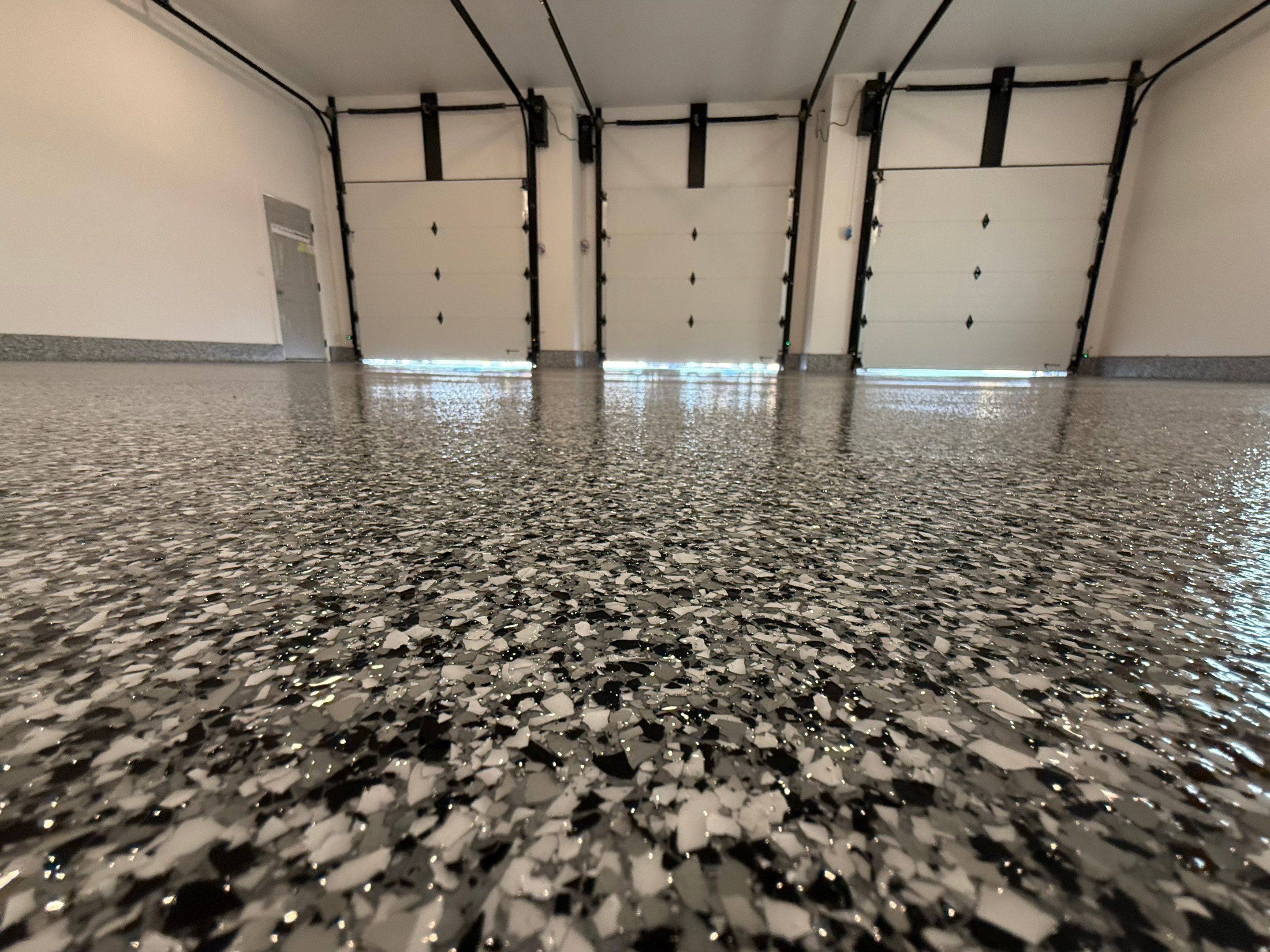 Multi-Car Garage Epoxy Floor Coating and Concrete Finishing in Sioux Falls by Select Painting, Coatings & Garage Cabinets