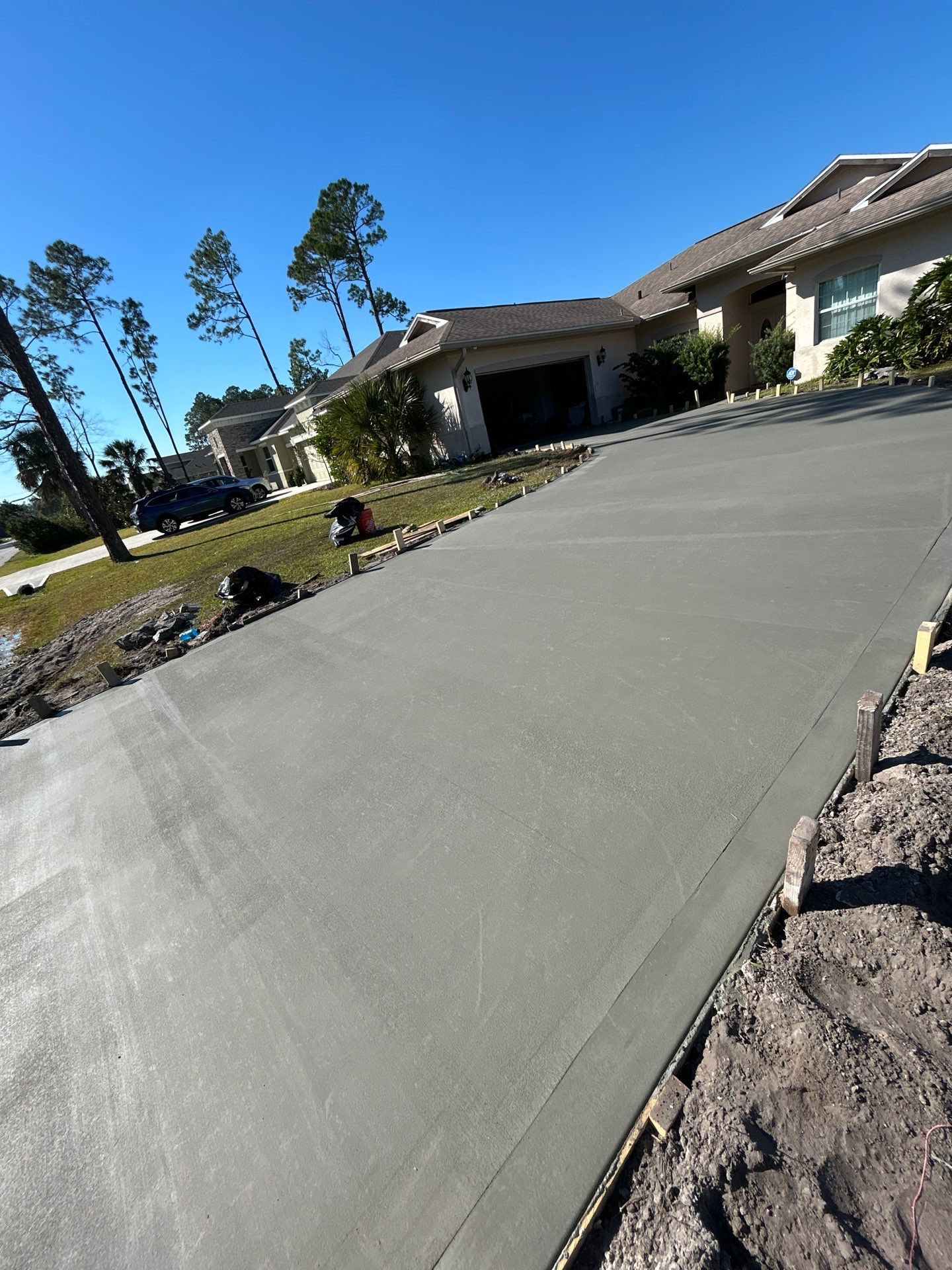 New concrete driveway by Courtesy screening