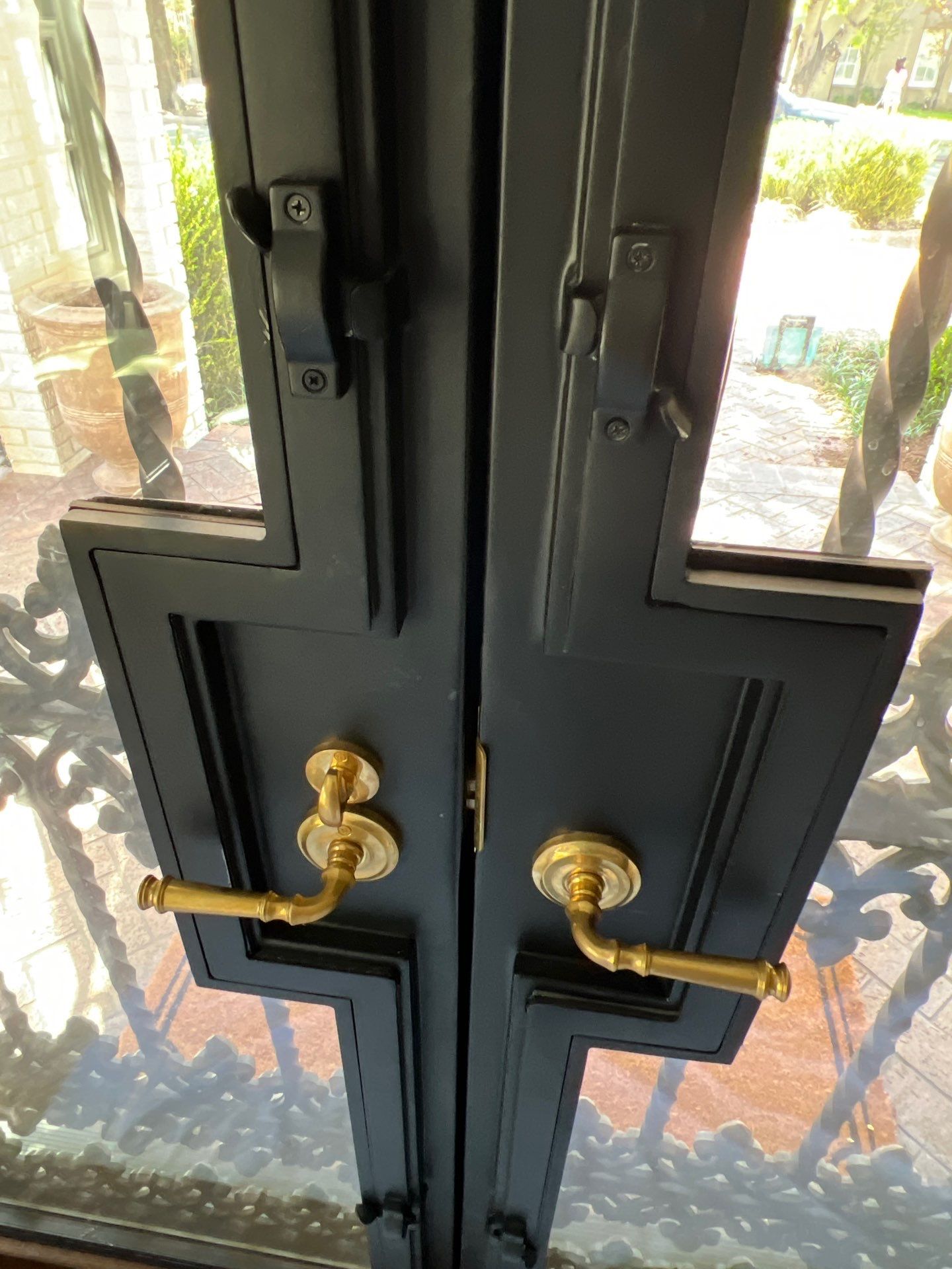 Custom Arched Black Wrought Iron Double Door Installation in Dallas by Solara Custom Living