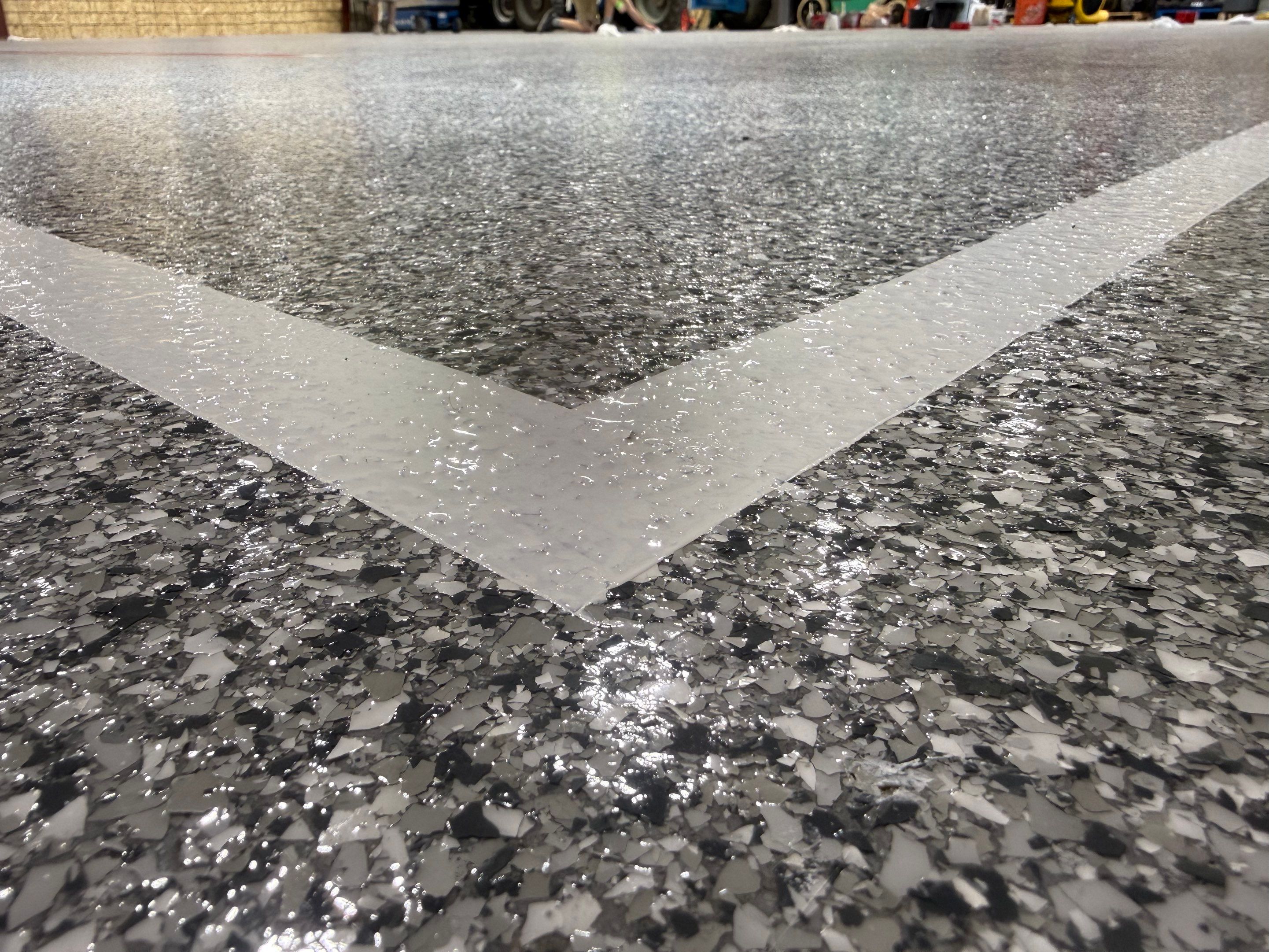 Custom Polyurea Shop Floor with Basketball Court Lines in Rock Valley by Select Painting, Coatings & Garage Cabinets