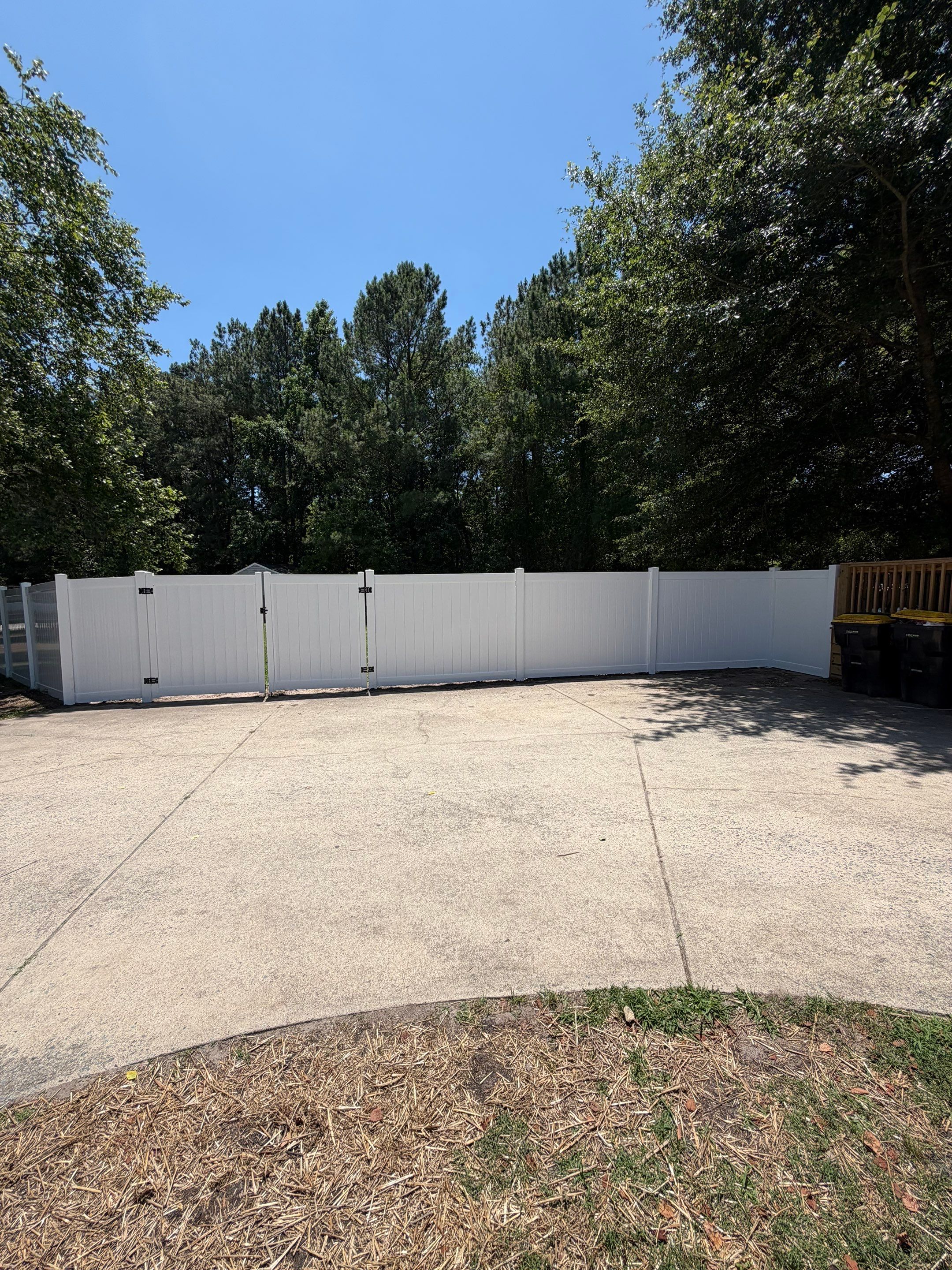 White Vinyl Privacy Fence Replacement with Double Gates in Greenville by Superior Fence and Rail