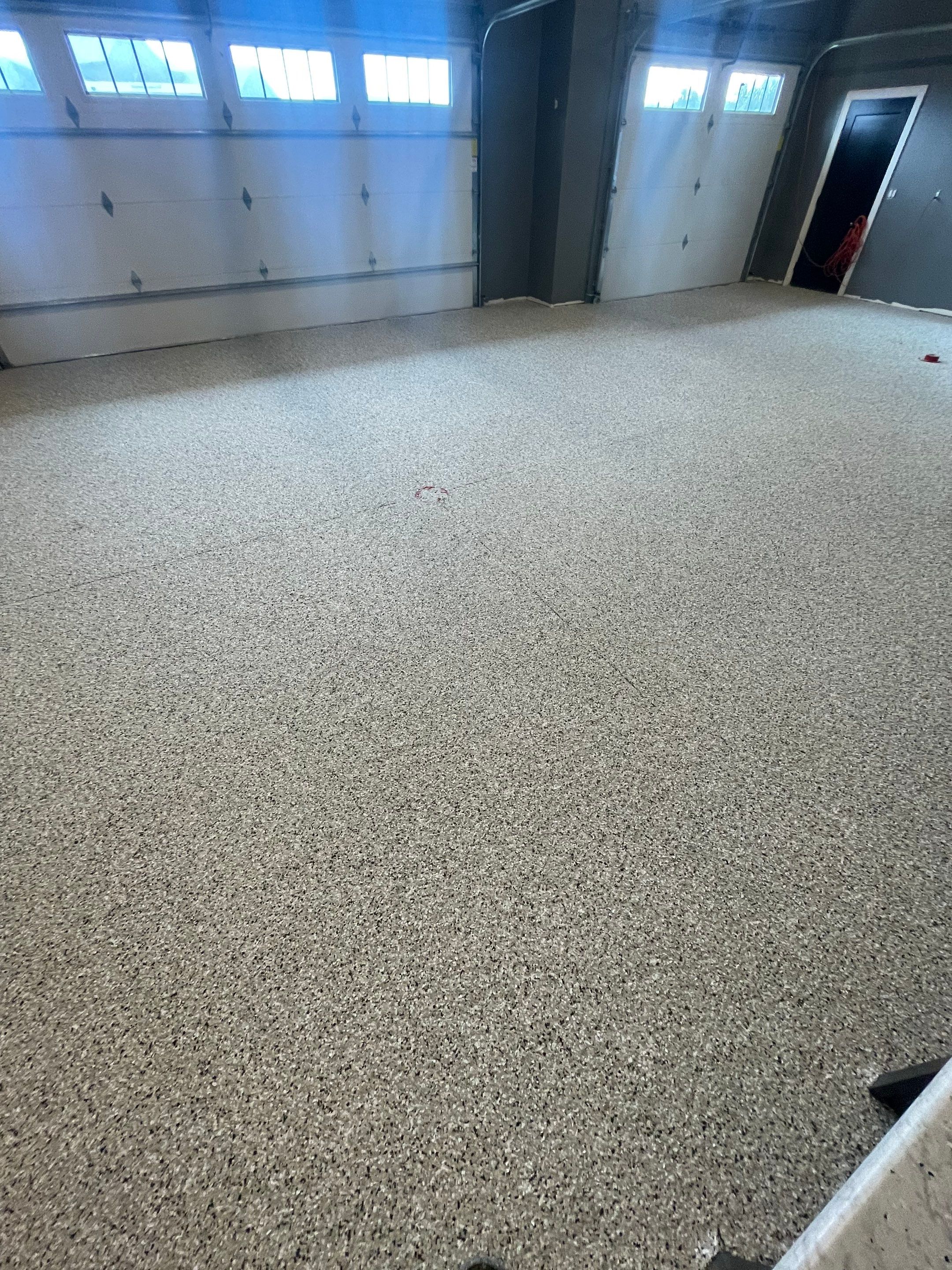 Custom Speckled Concrete Coating for Dell Rapids Garage by Select Painting, Coatings & Garage Cabinets