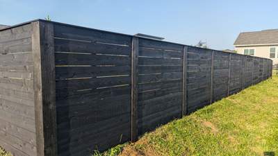 Modern Black Stained Horizontal Privacy Fence Installation in Cedar