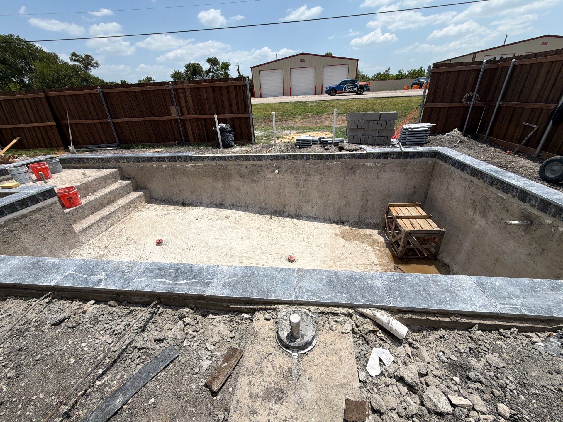 Geometric Pool with Raised Stone Waterfall Wall by Pinnacle Pools and Spas - DFW