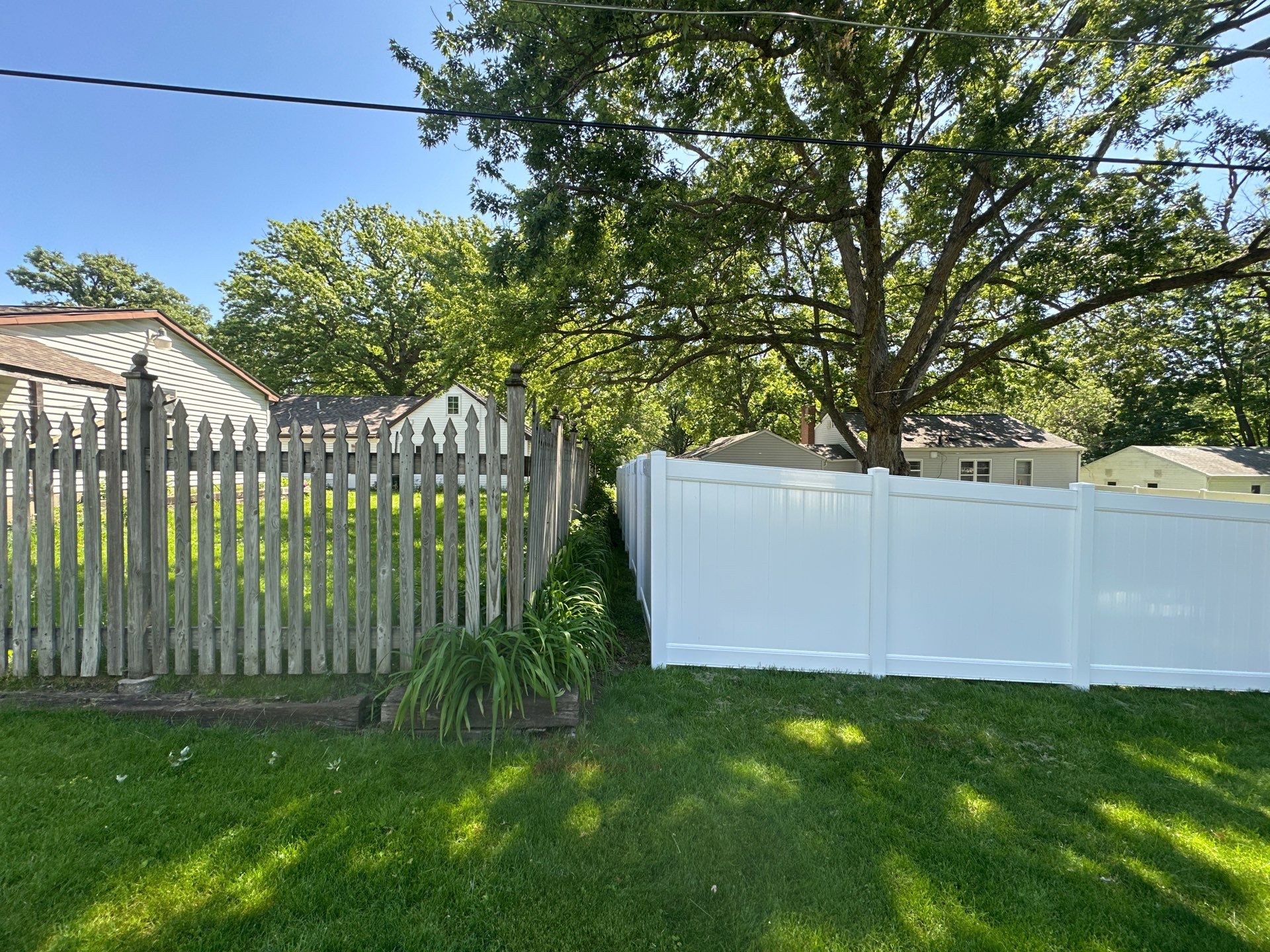 White Vinyl Privacy Fence and Double Gate Installation in Cedar Falls by Perfect Picket Fence and Stain
