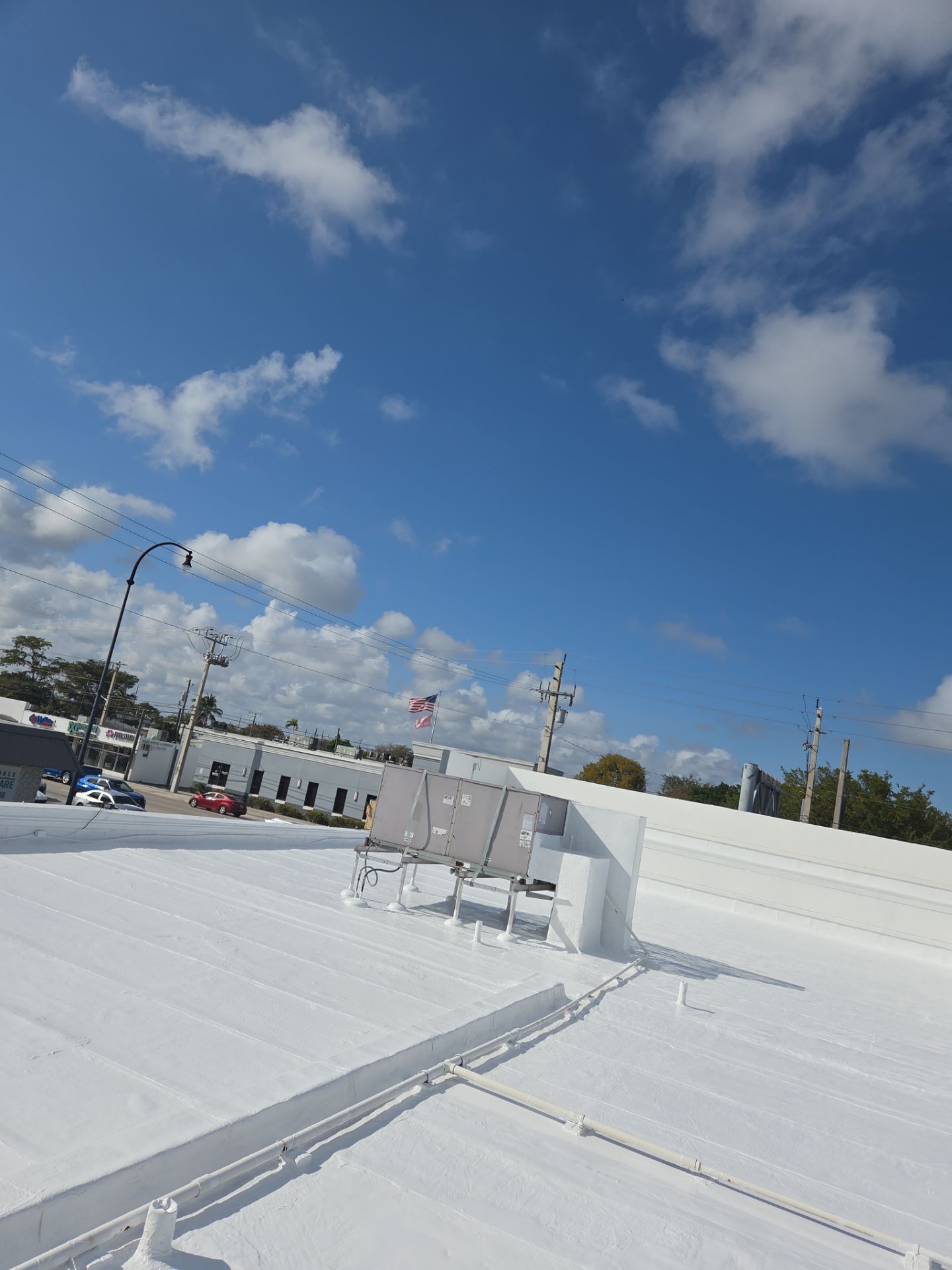 Commercial Flat Roof Restoration Using Silicone Coating in Hallandale Beach by Aastro Roofing