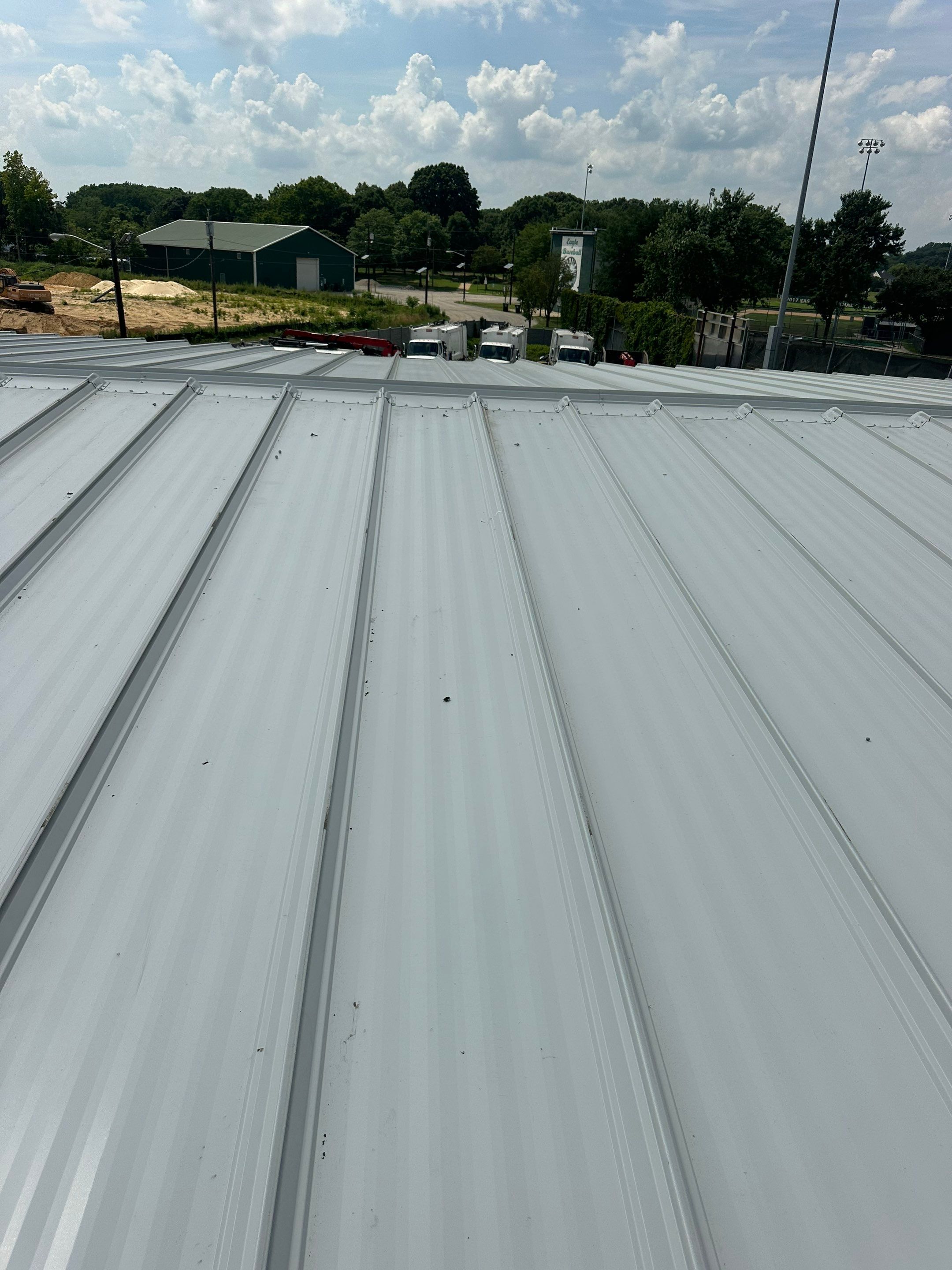 Dark Green Metal Siding by Reimagine Roofing