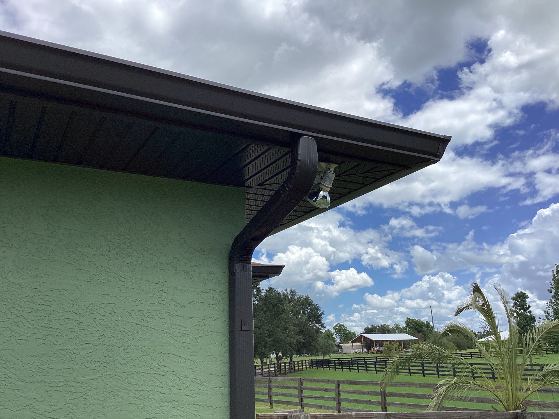 Musket brown downspouts with 6-inch K-Style gutter installation in Myakka City, FL by Gutter Professors