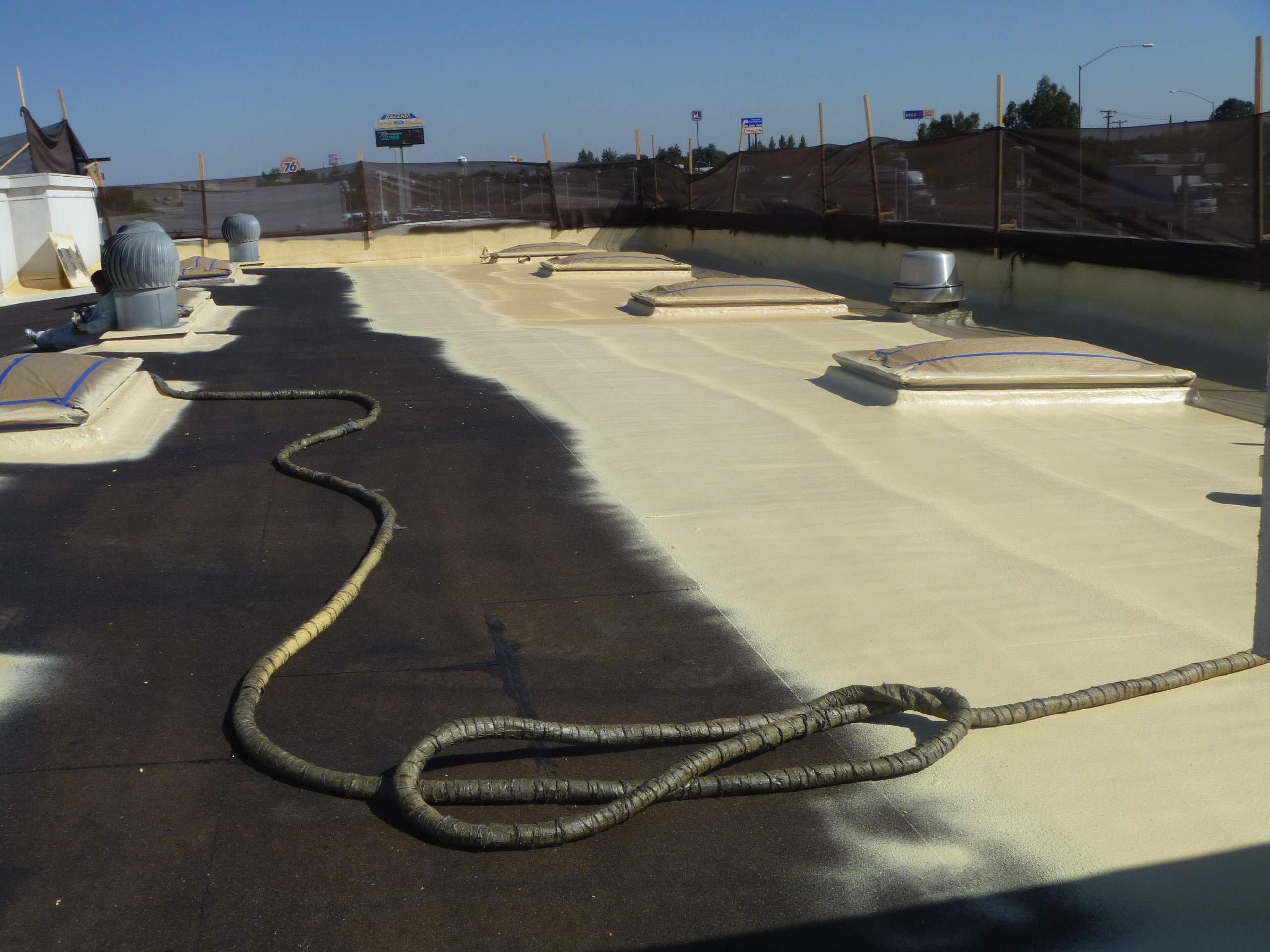 Commercial Roofing Installation using Spray foam and Conklin Benchmark/PUMA XL 18 yr warranty coatings by Straight Edge Roofing Inc