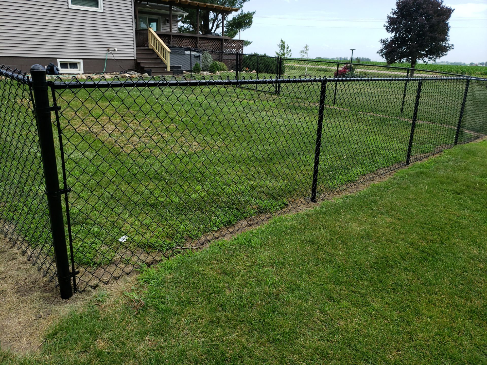 Black Vinyl-Coated Chain Link Fence Installation in Fredericksburg by Perfect Picket Fence and Stain