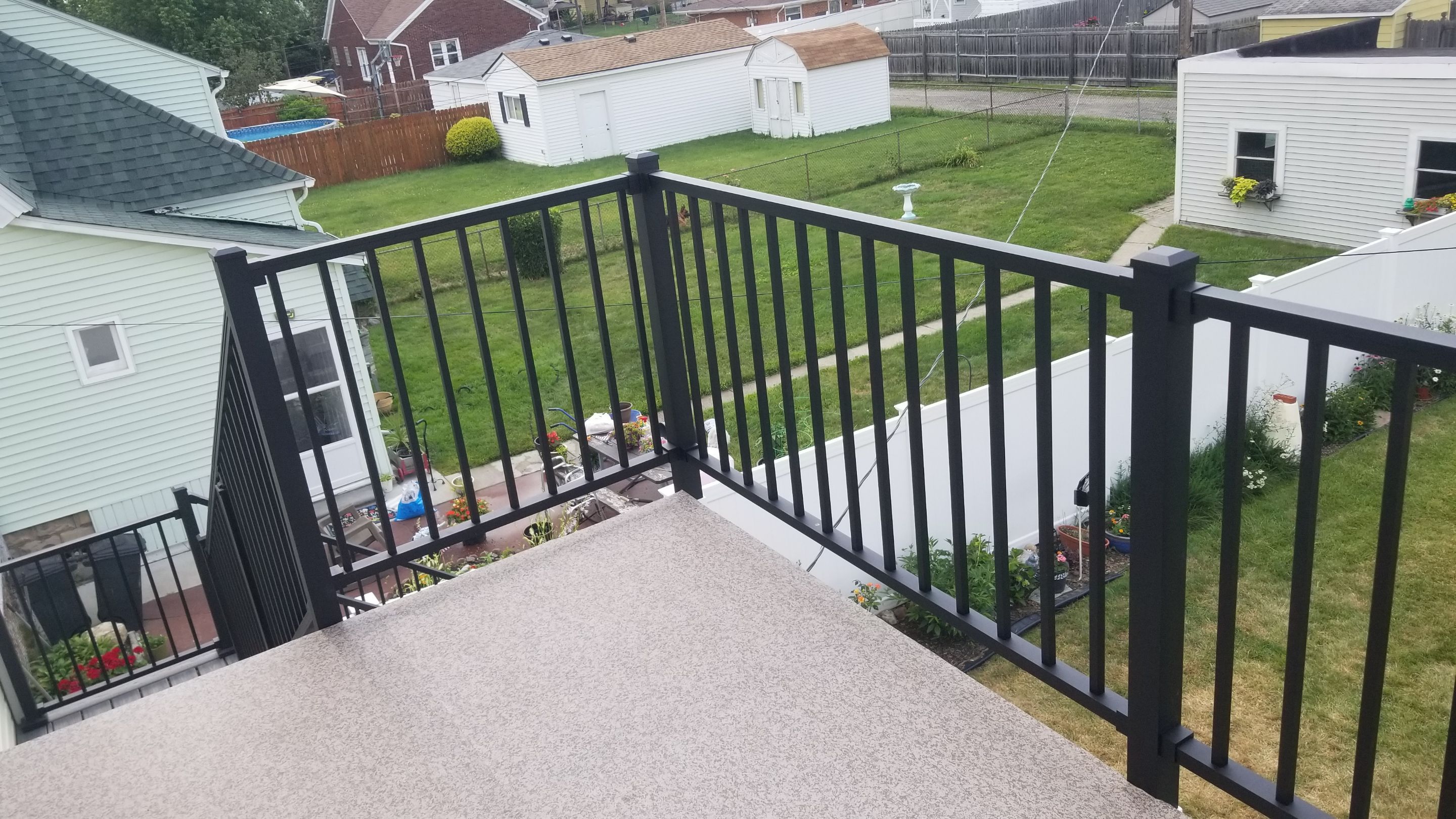 Rebuild balcony flat roofing TREX decking stairway and Railings in Wyandotte, MI by Northwest Construction 
