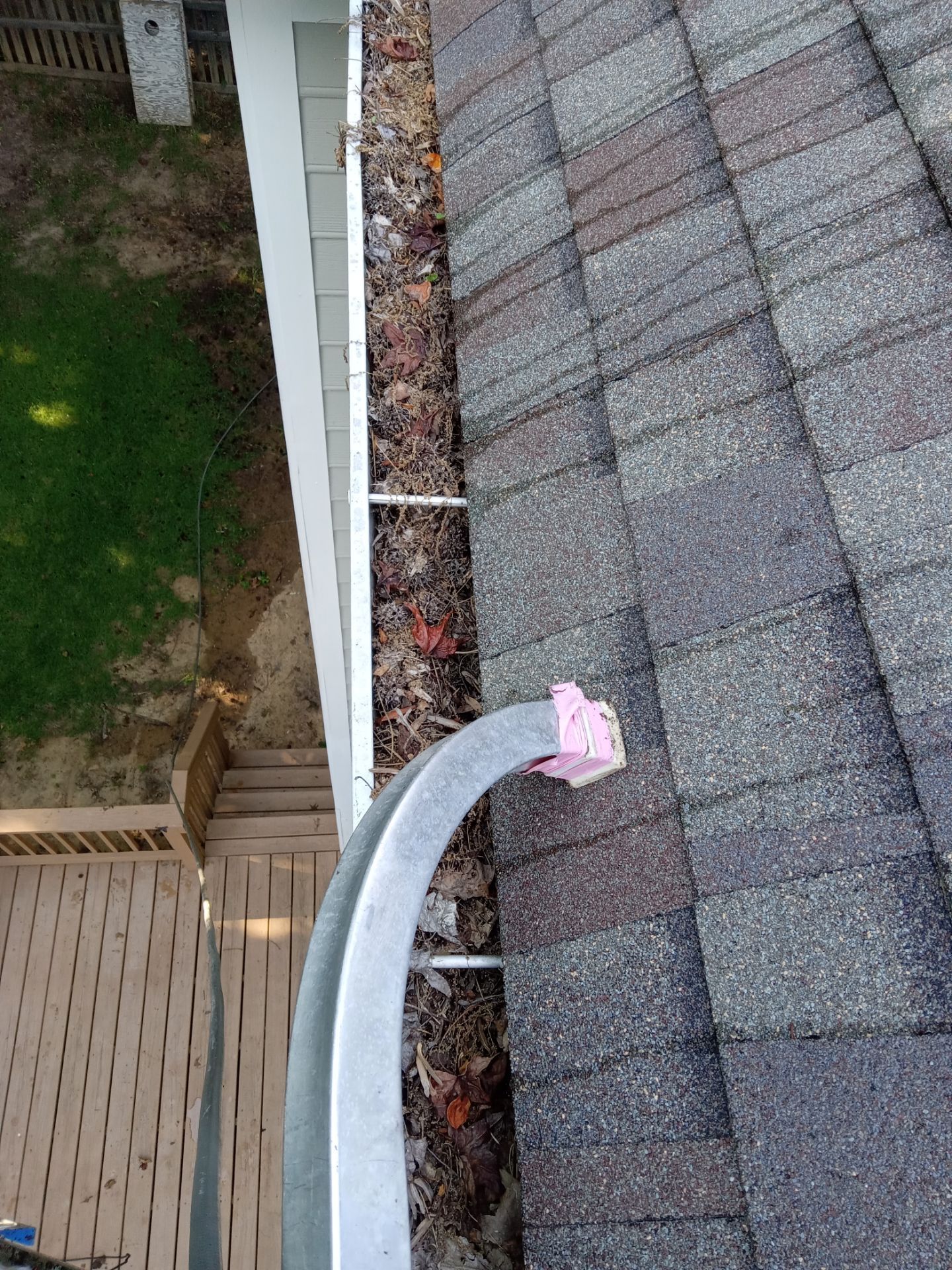 gutter cleaning removing leaves and debris from roof and gutter system