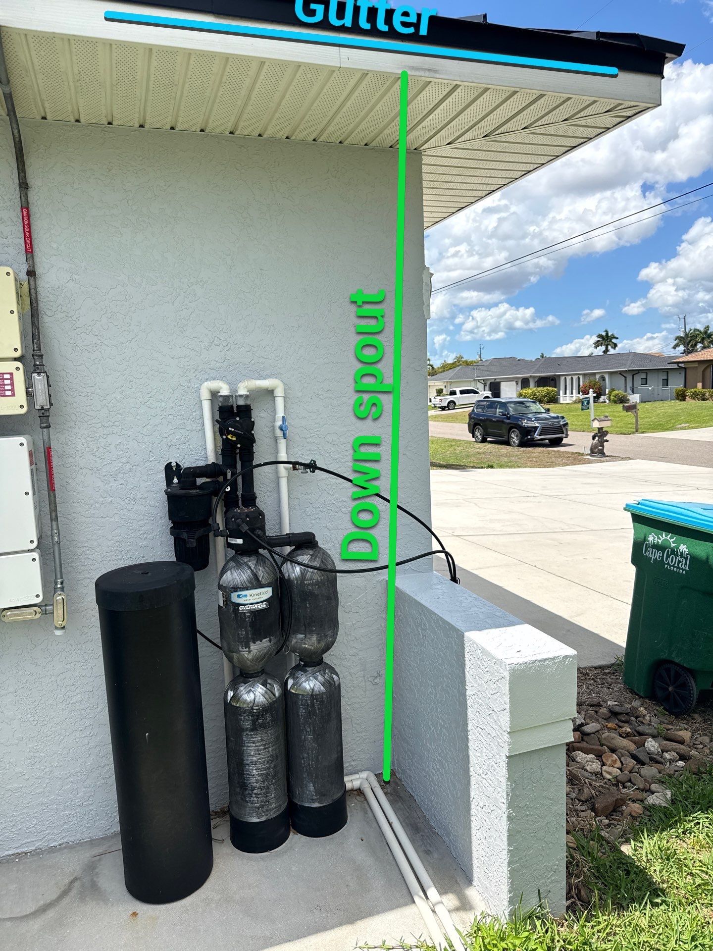 Black Seamless Gutters and White Downspouts in Cape Coral FL by Gutter Professors