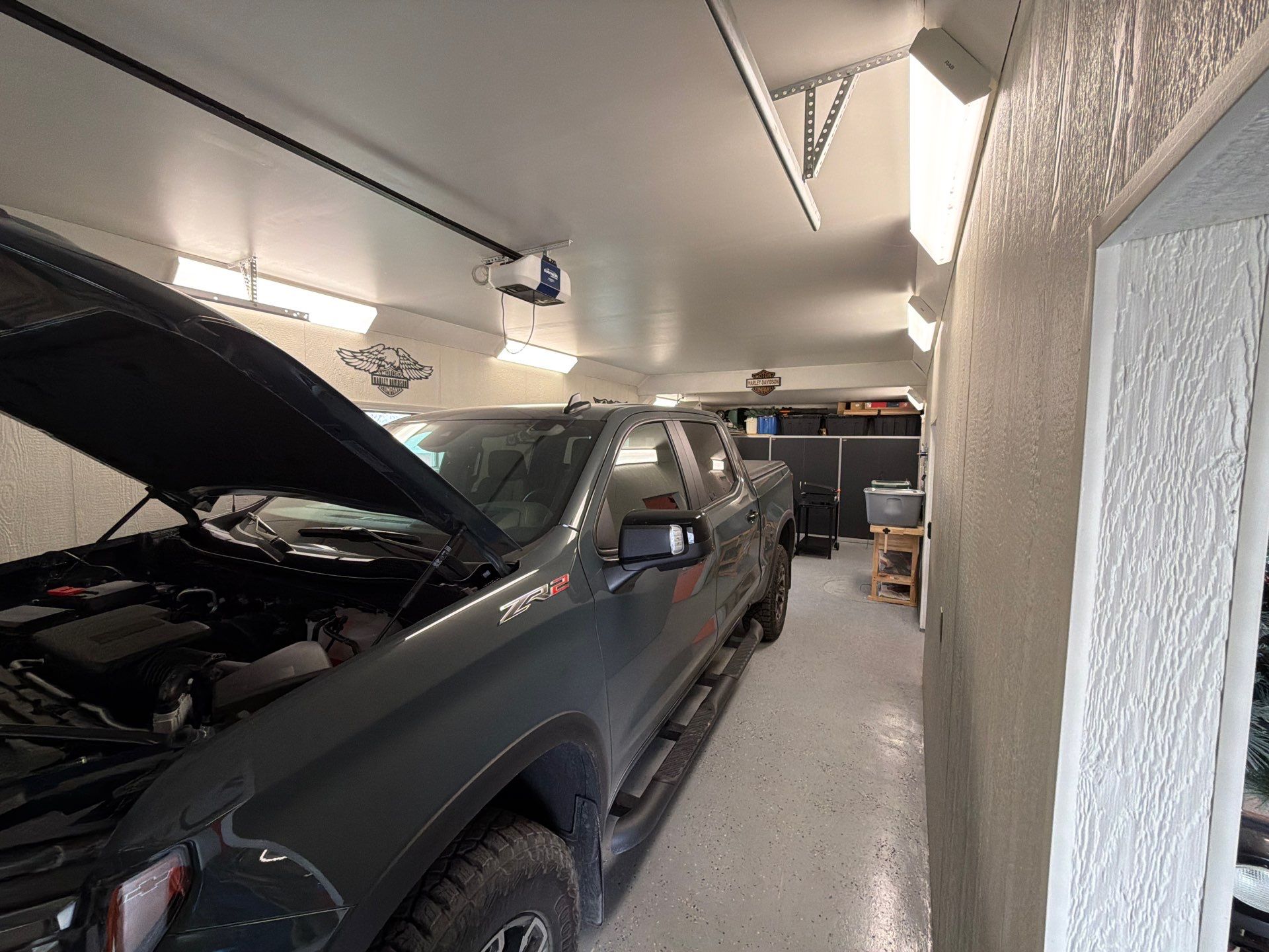 Custom Grey Flake Epoxy Garage Floor Installation in Remsen by Select Painting, Coatings & Garage Cabinets
