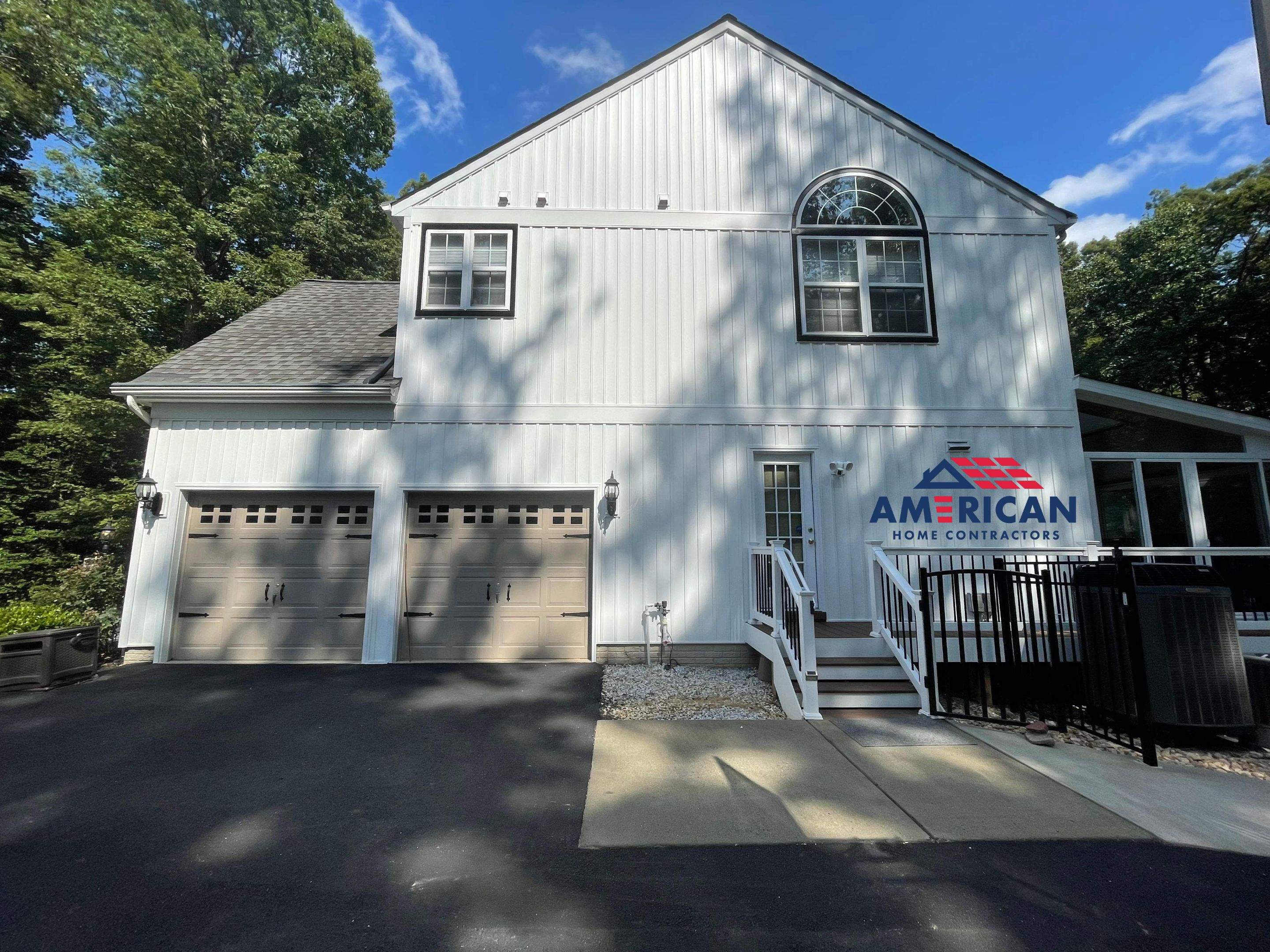 Vinyl Siding Replacement + Black Trim by American Home Contractors