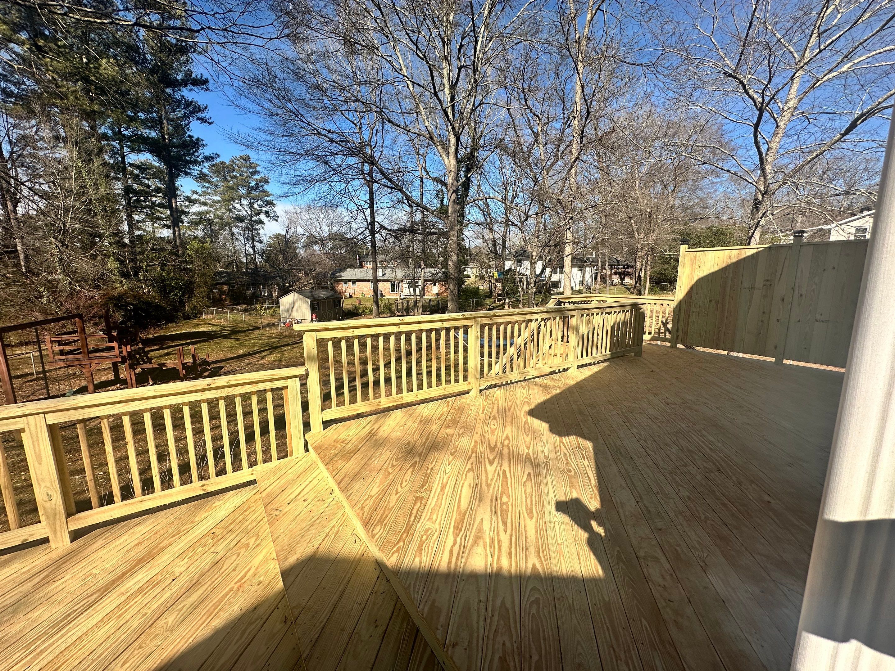 Elevated Pressure-Treated Wood Deck Extension in Marietta by Swift Home Renovations