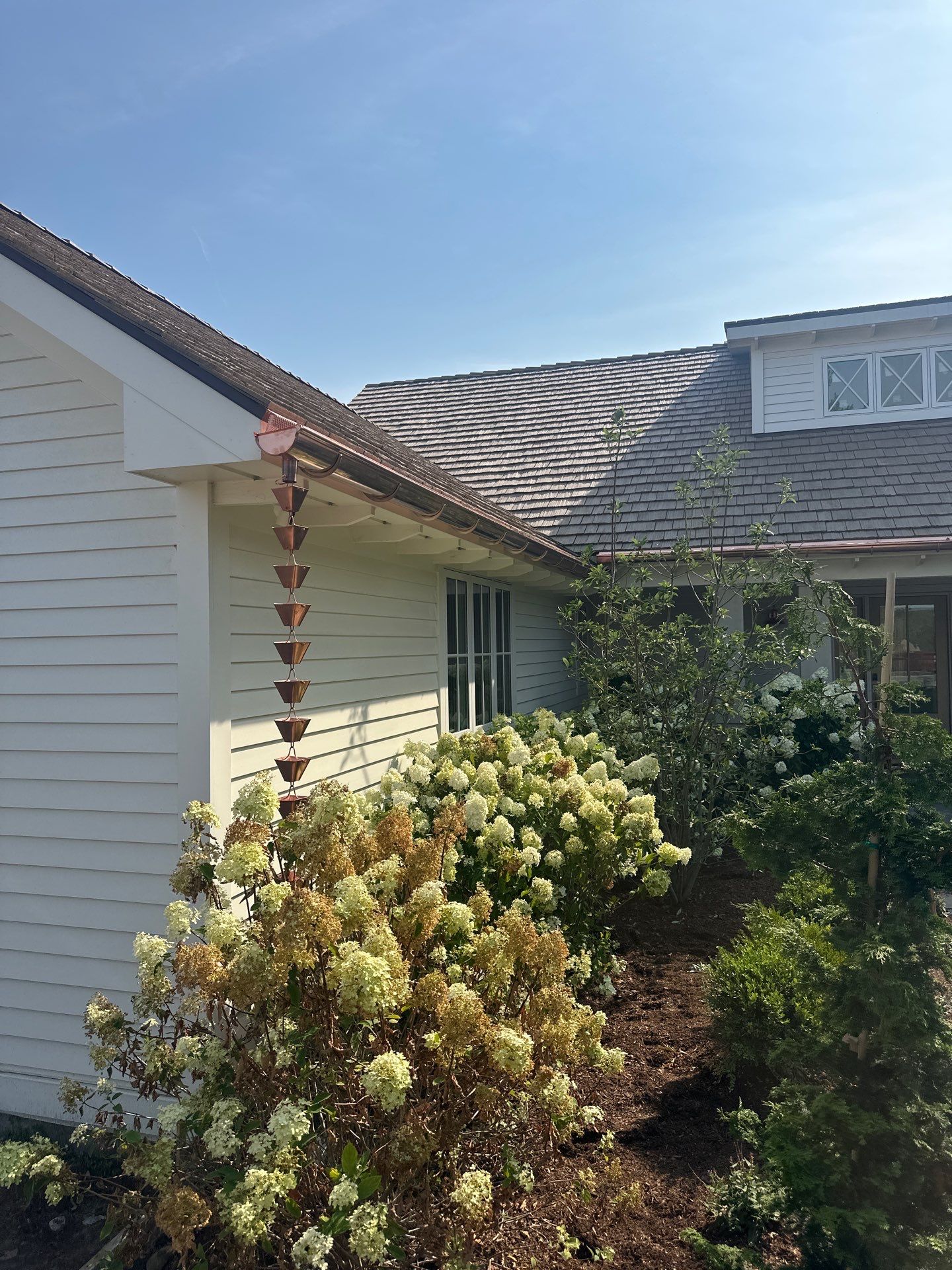 Custom Copper Gutter System and Accent Roofing in East Jordan by Rainbow Seamless Systems