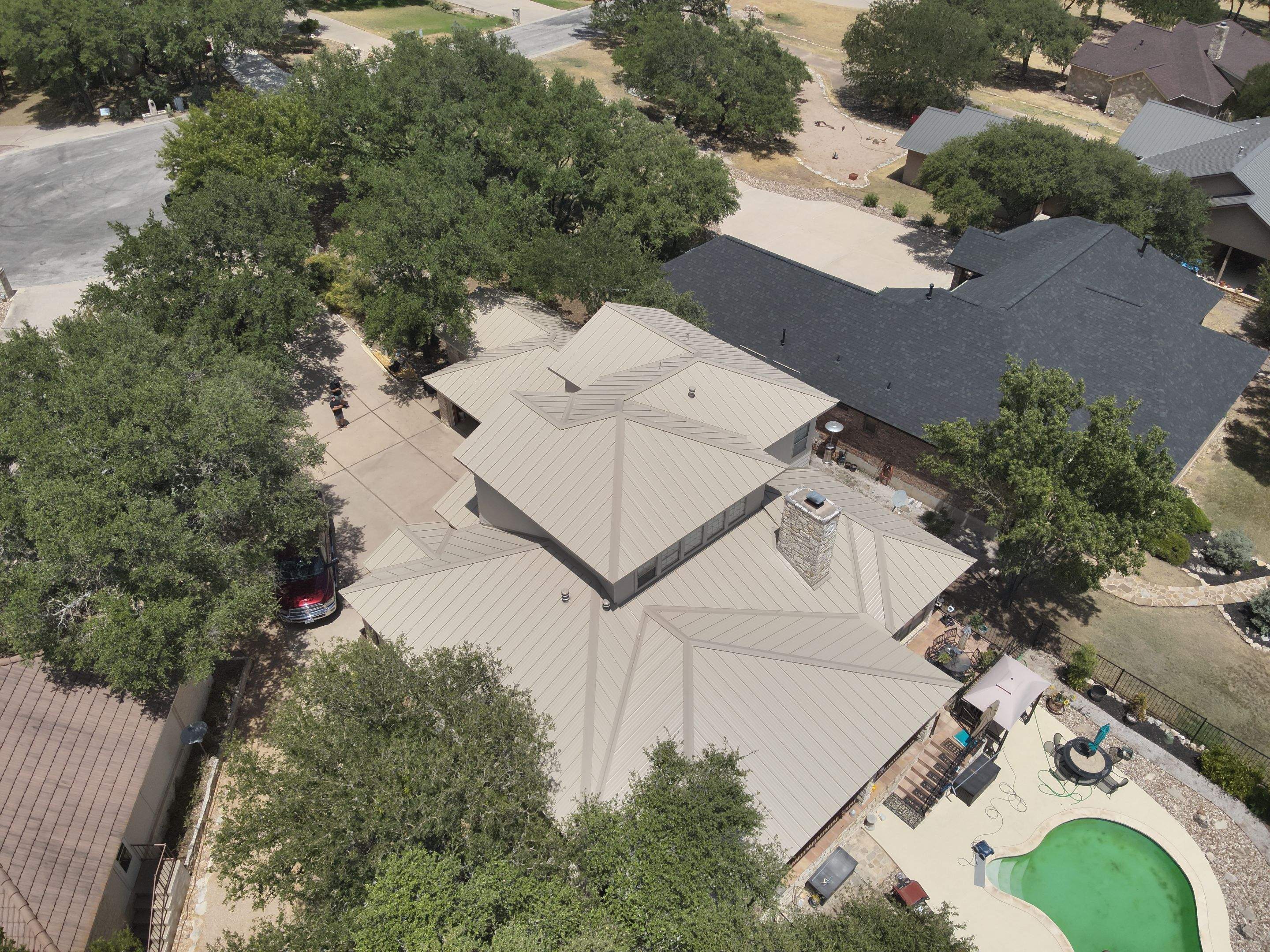 Residential Roof Replacement using 24 GA Double-Lock - Surrey Beige by Action Exteriors Austin