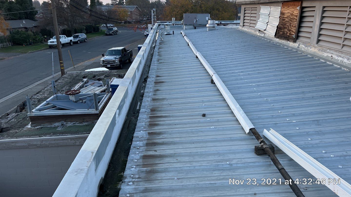 Metal roof restoration on commercial roof using Conklin Benchmark/ PUMA XL acrylic coatings over metal and foam by Straight Edge Roofing Inc