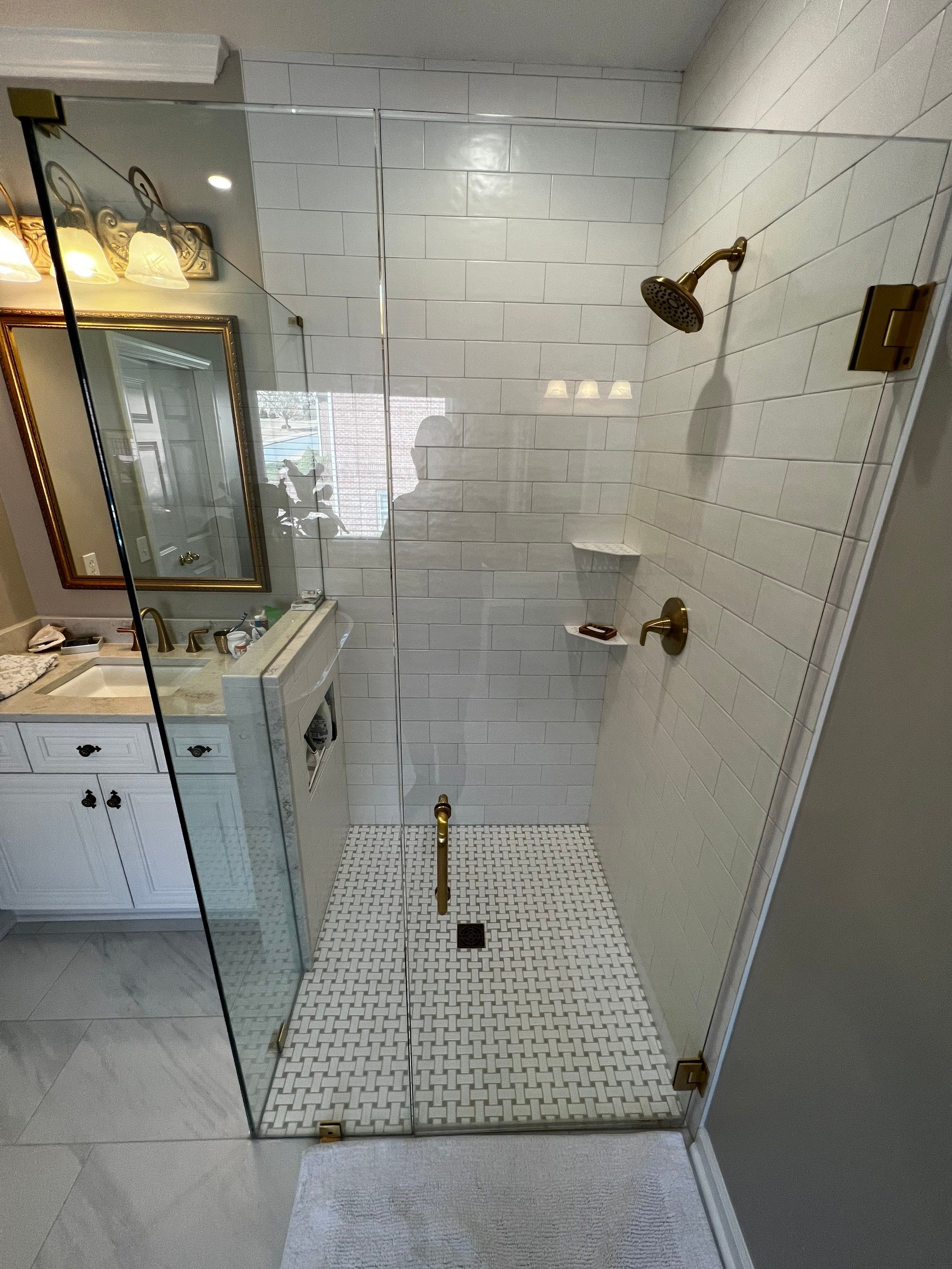 Master Bathroom Renovation with Marble Floor and Freestanding Soaking Tub by Swift Home Renovations