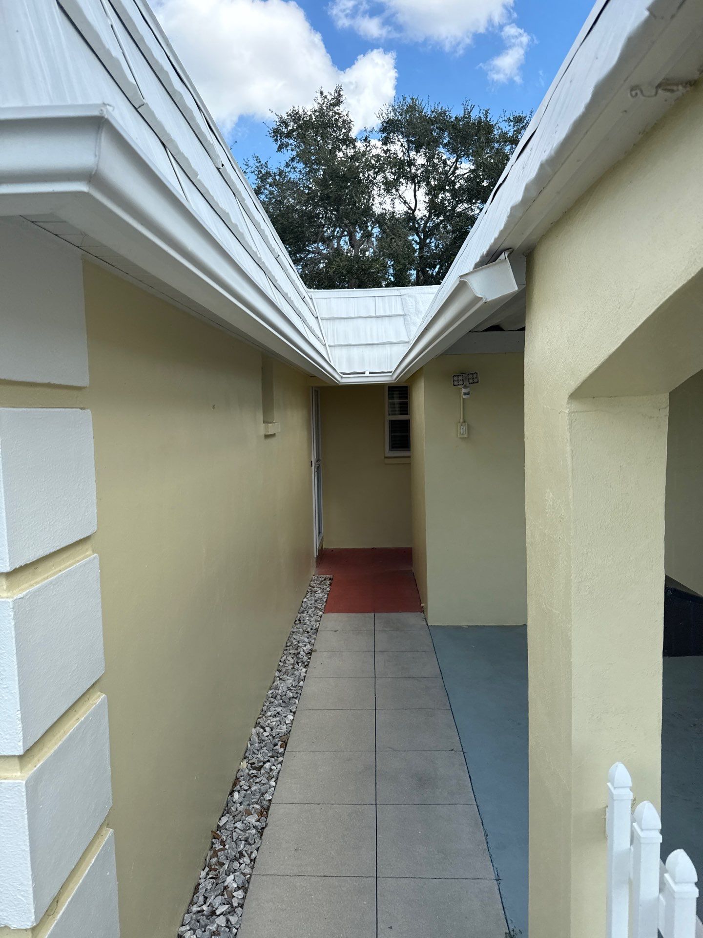 White Gutters and Matching Downspouts in Sarasota FL by Gutter Professors