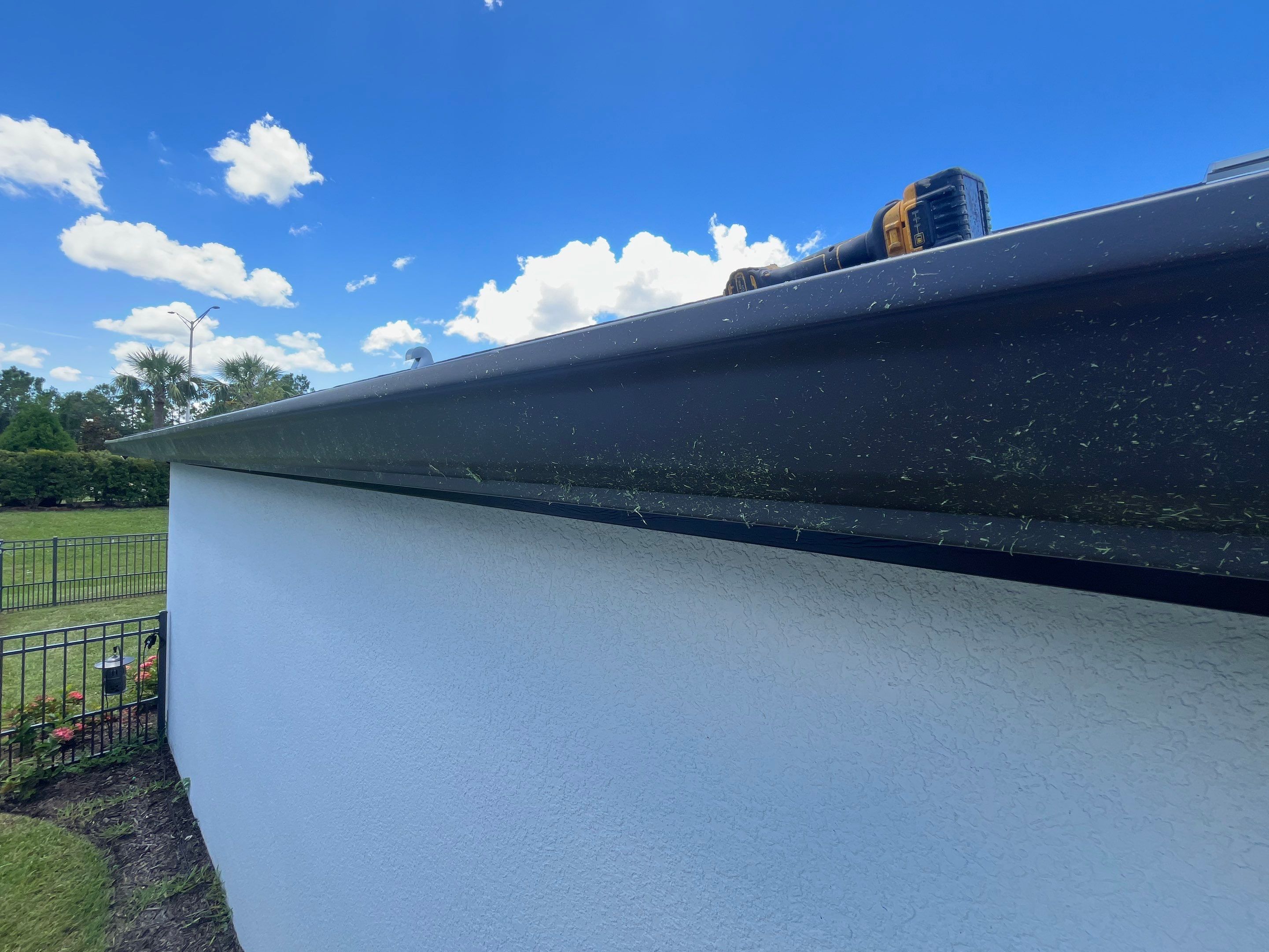 Dark Bronze Gutters and White Downspouts in Sarasota FL by Gutter Professors