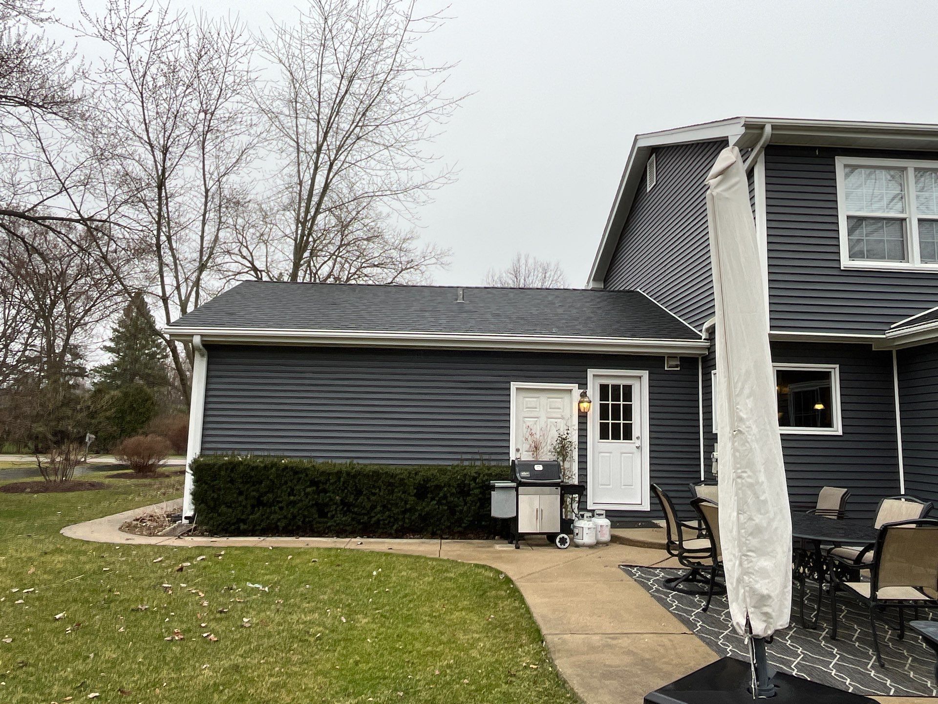 Asphalt Roof Replacement with Aluminum Gutter Installment by Custom Installations