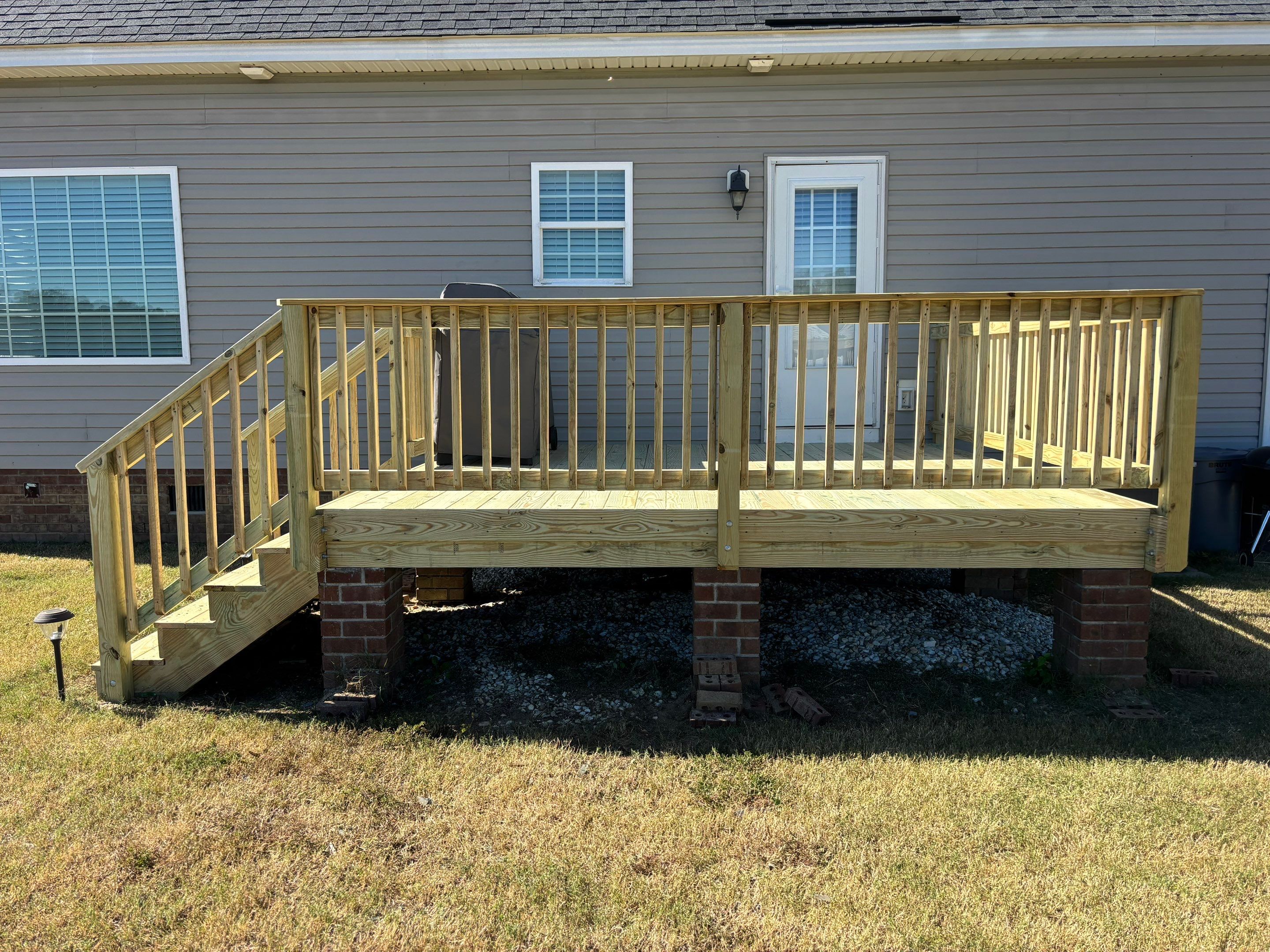 Pressure-Treated Wood Deck Resurface and Railing Replacement in Battleboro by The Remodeling Company
