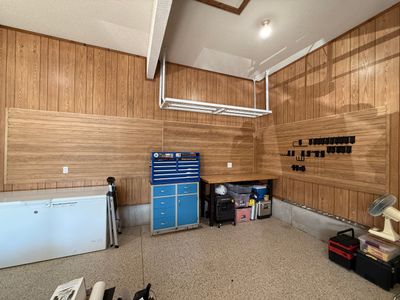 Garage Organization With Overhead Racks and Slatwall in Overland Park