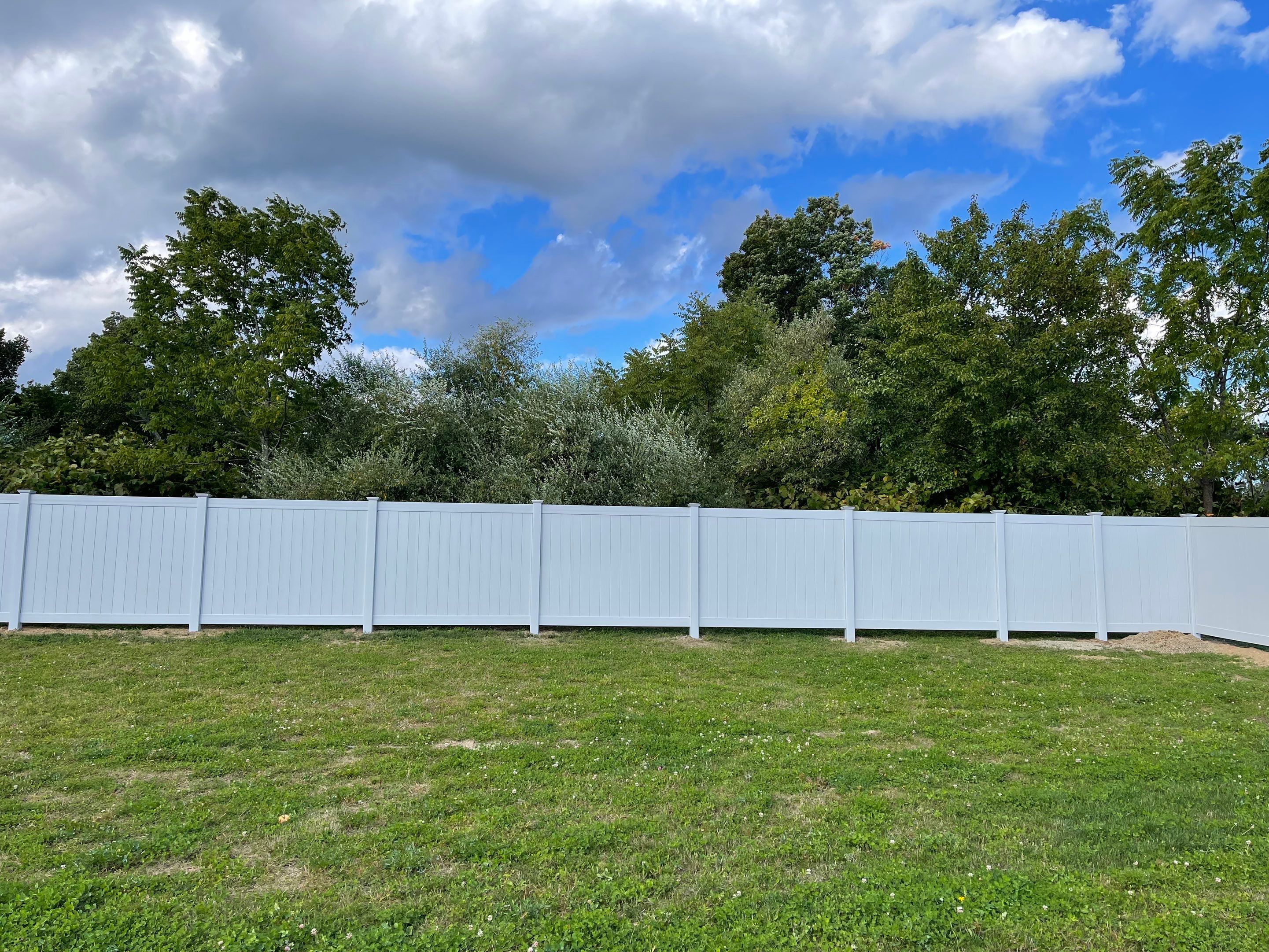 New Vinyl privacy fence with matching gates in Classic Gray by DiGiorgi Roofing and Siding Inc