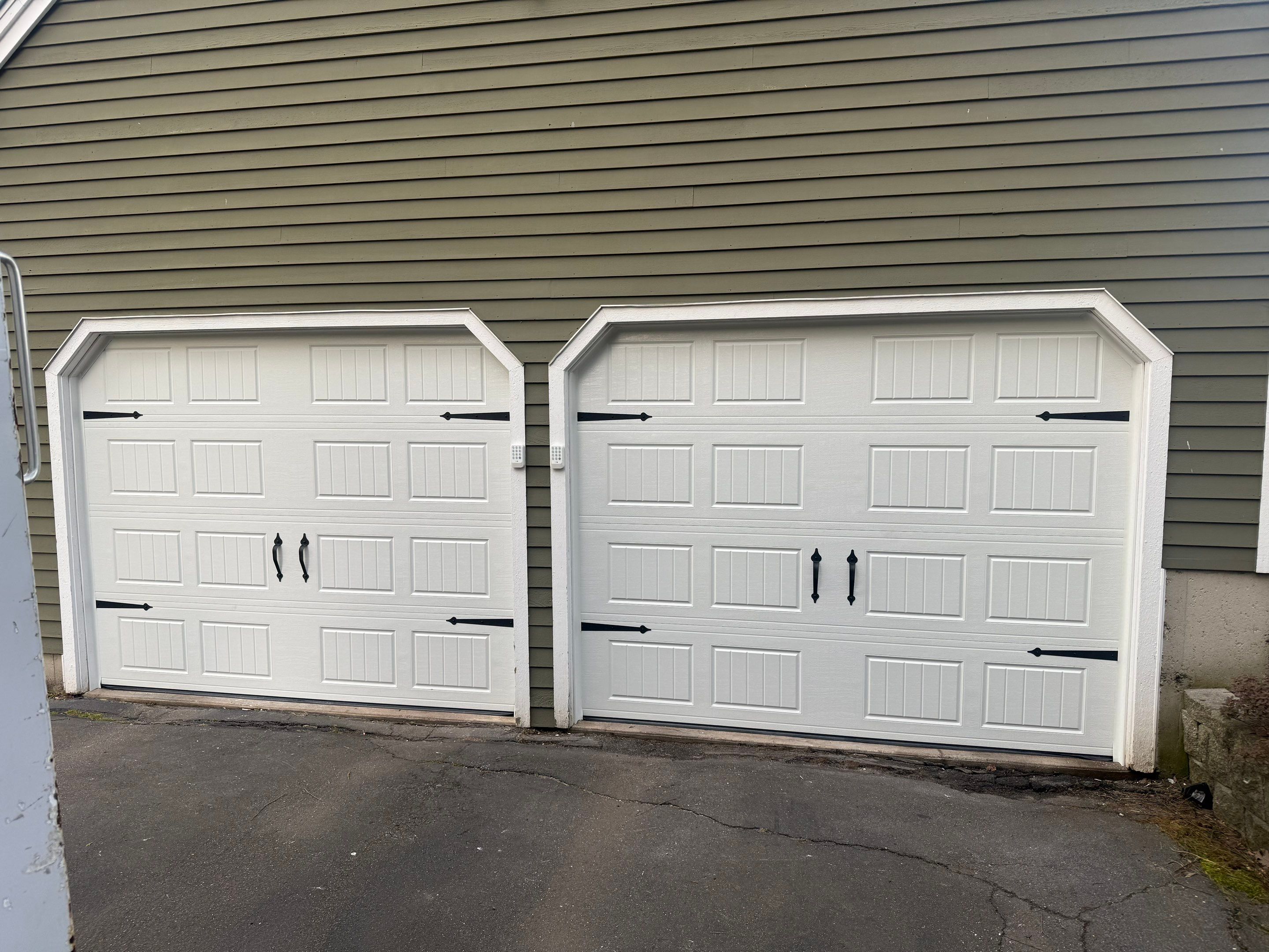 Clean Garage Door Upgrade with Modern Hardware Detail by DiGiorgi Roofing and Siding Inc