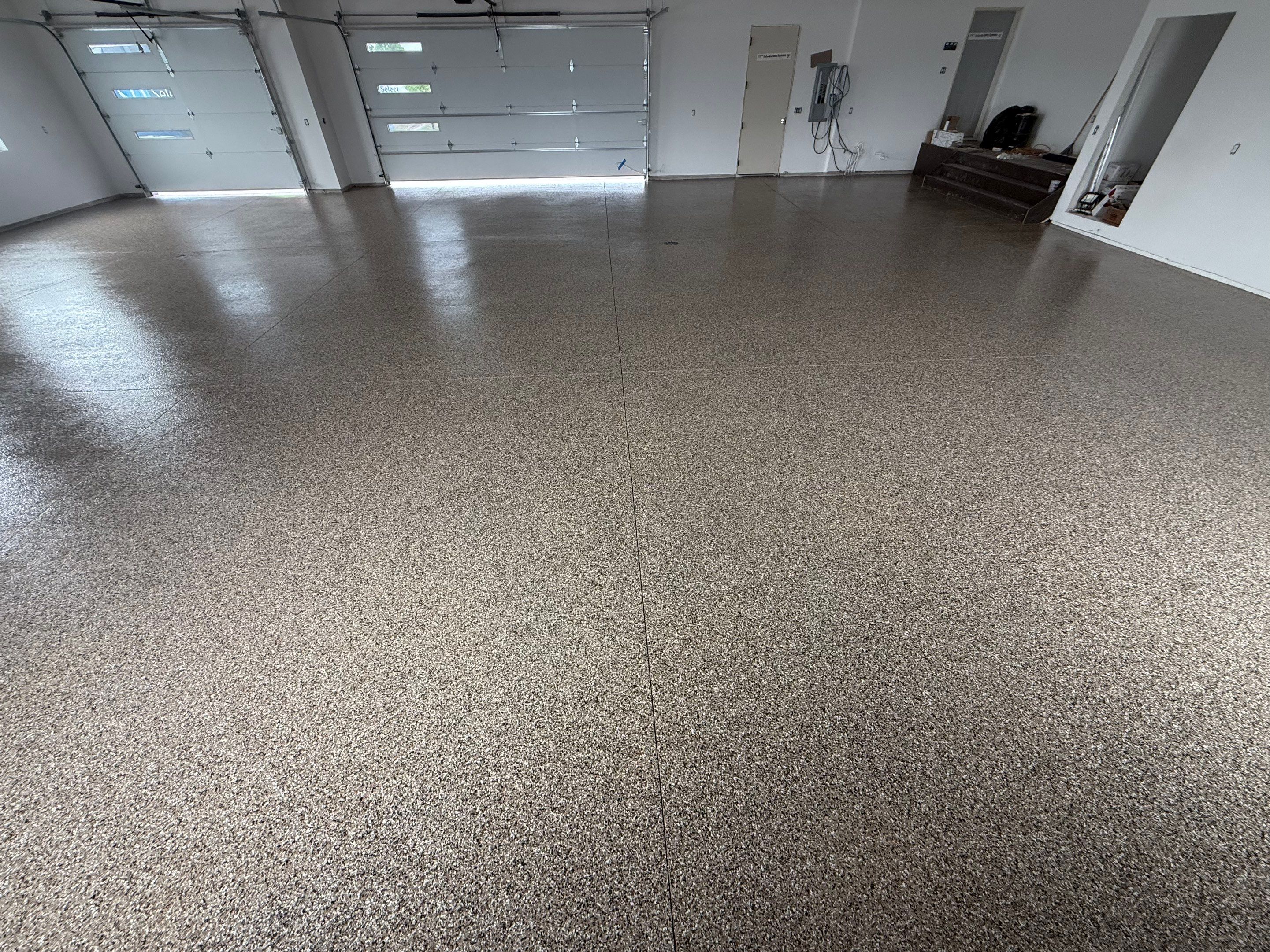 Multi-Bay Garage Concrete Coating and Floor Refinishing in South Dakota by Select Painting, Coatings & Garage Cabinets