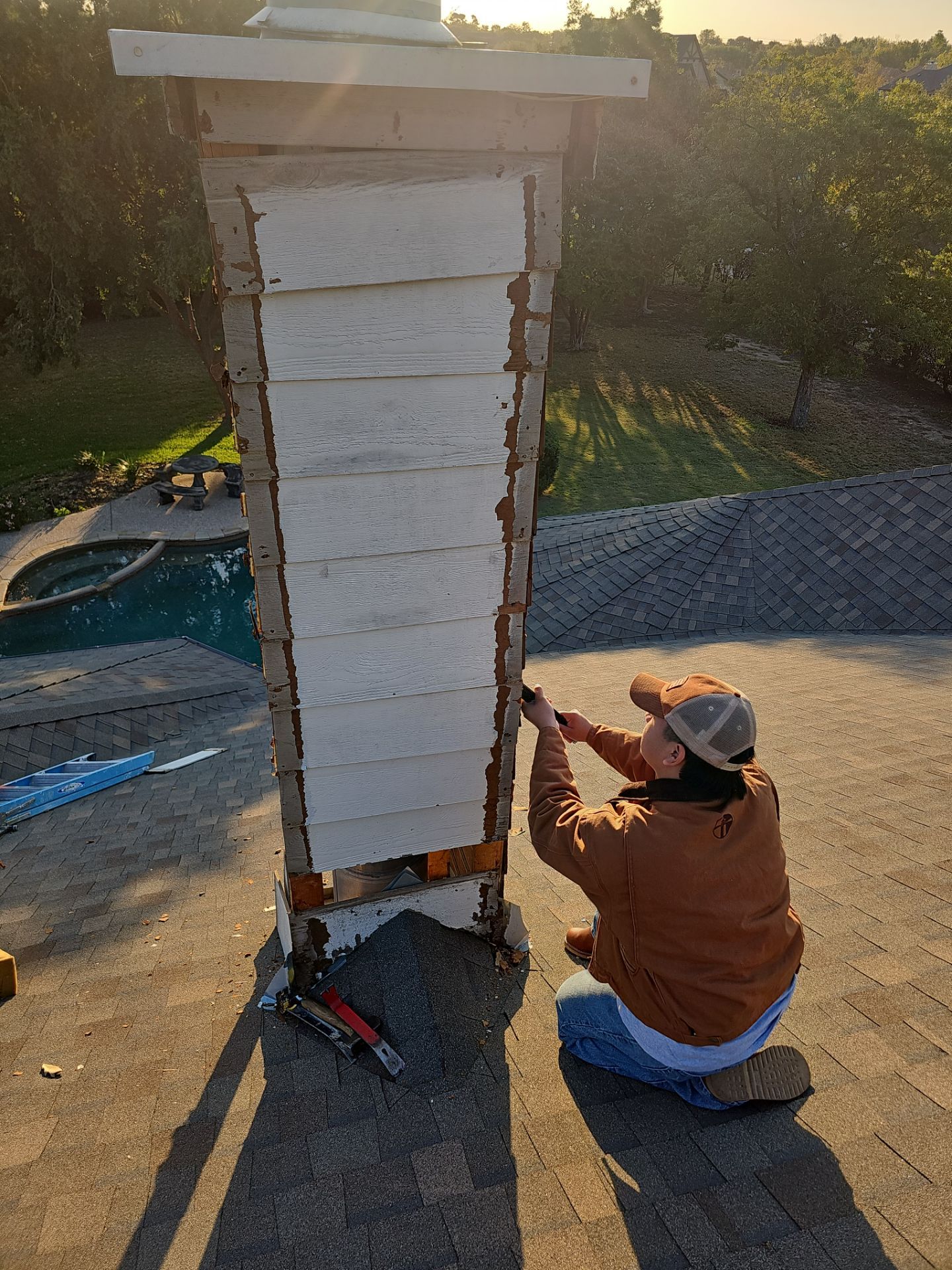 chimney repair using lap engineered treated composite siding. by road roofing llc