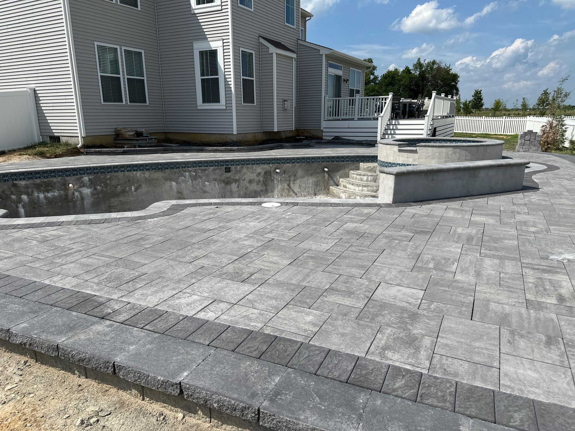 Pool and Hardscape Design in Delaware | Belgard Paver Patio & Outdoor Living Space by Studio G Indoor Spaces & Outdoor Living