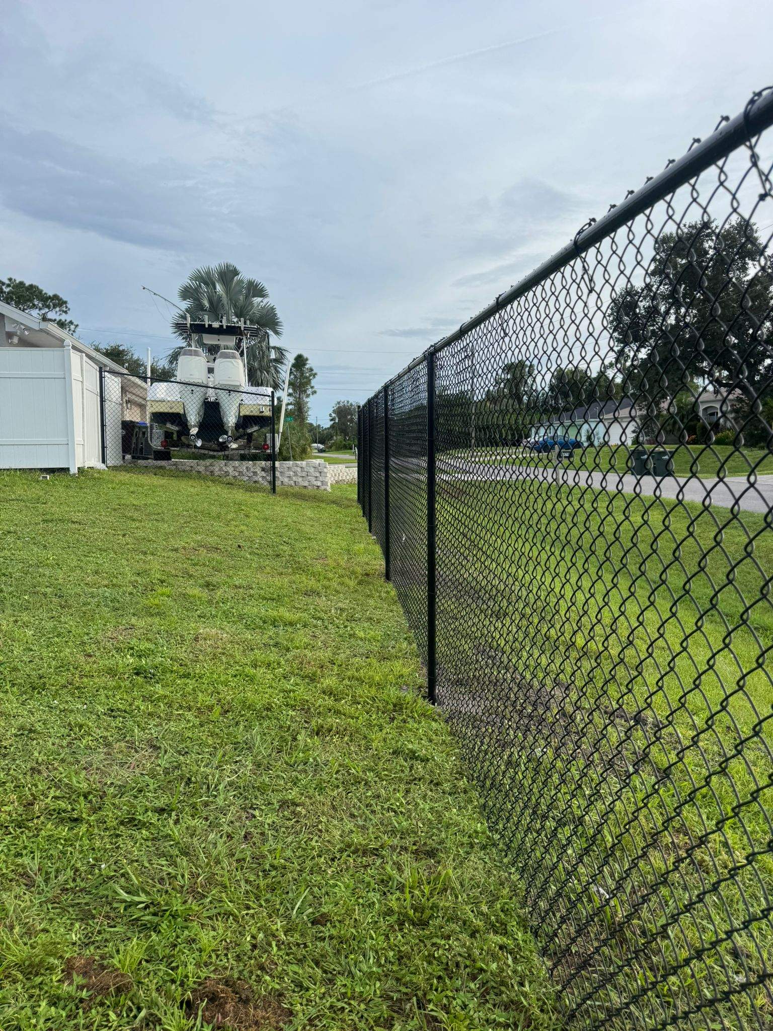Black Vinyl-Coated Chain Link Fence and Gate Installation in North Port by True Fence LLC