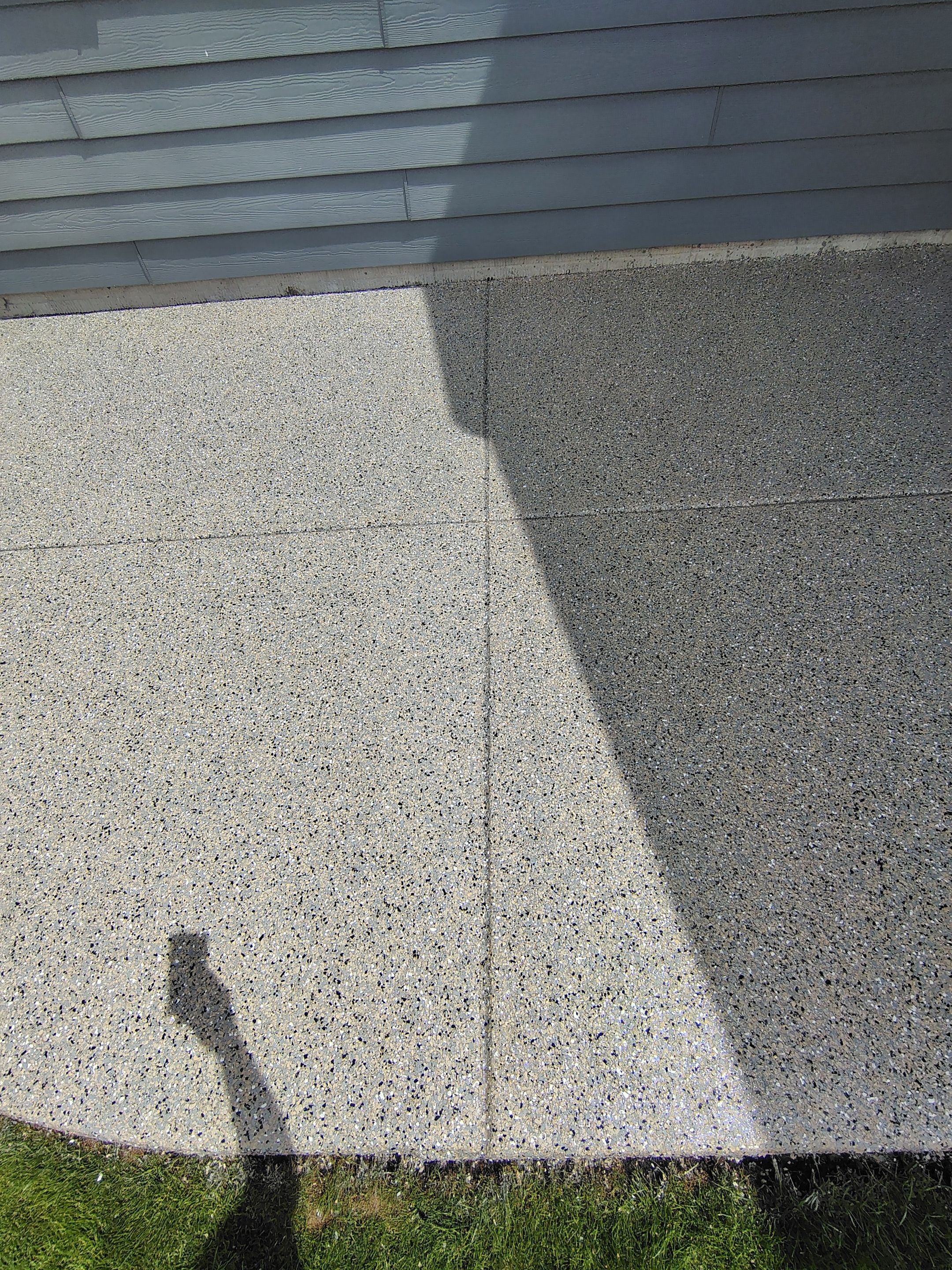 Speckled Concrete Patio Coating Installation in Sioux Falls by Select Painting, Coatings & Garage Cabinets