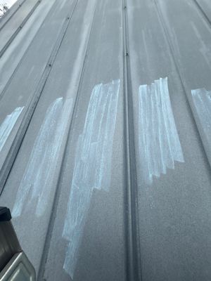 Close up of metal roof panel with chalk markings