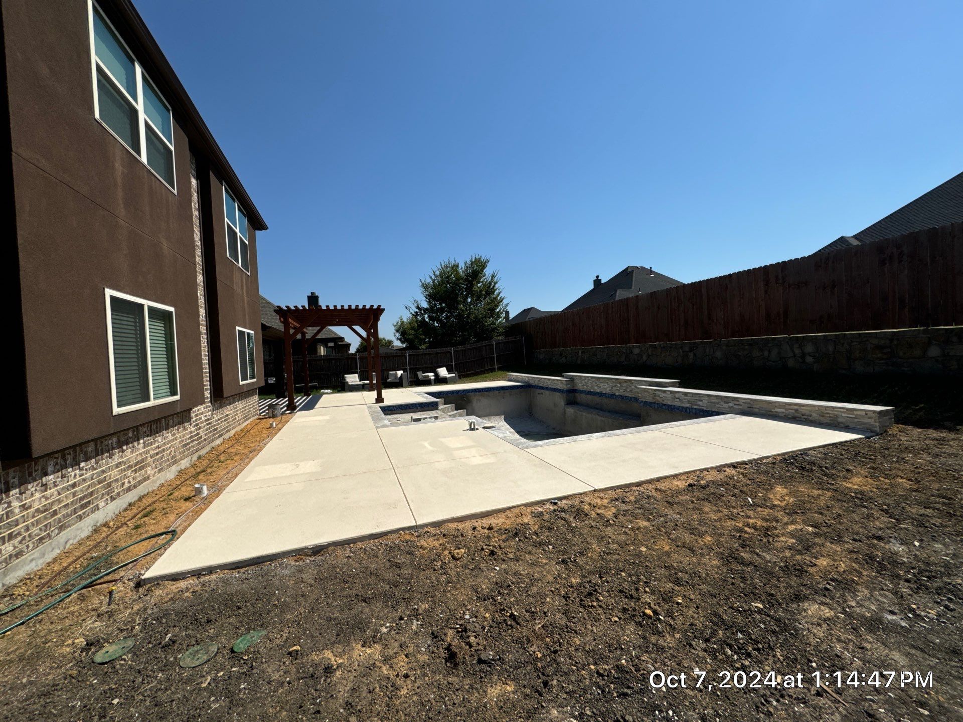 Modern Geometric Pool with Raised Stone Wall and Paver Deck by Pinnacle Pools and Spas - DFW