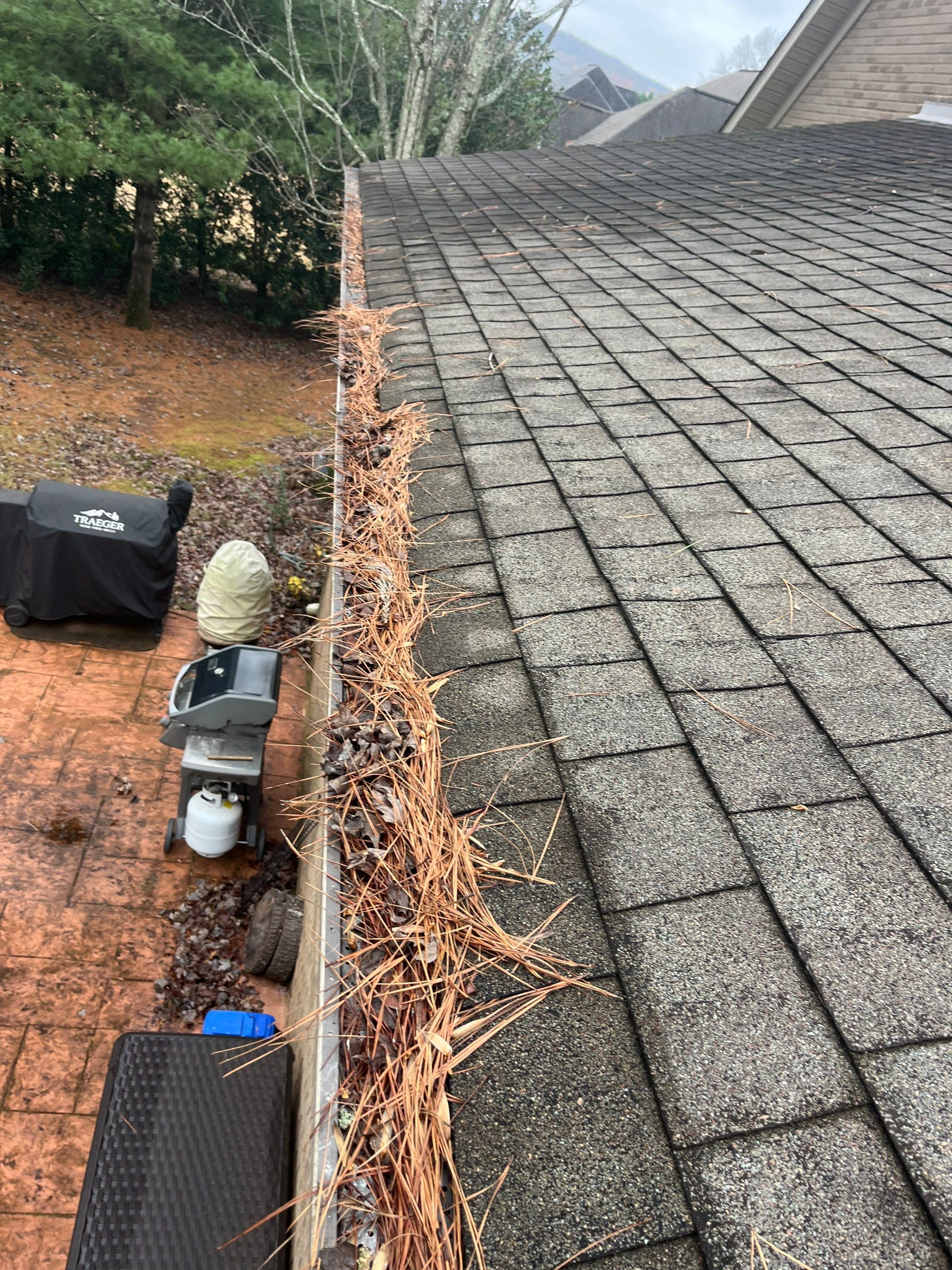 Commercial gutter cleaning Huntsville, AL before photo with filled gutters