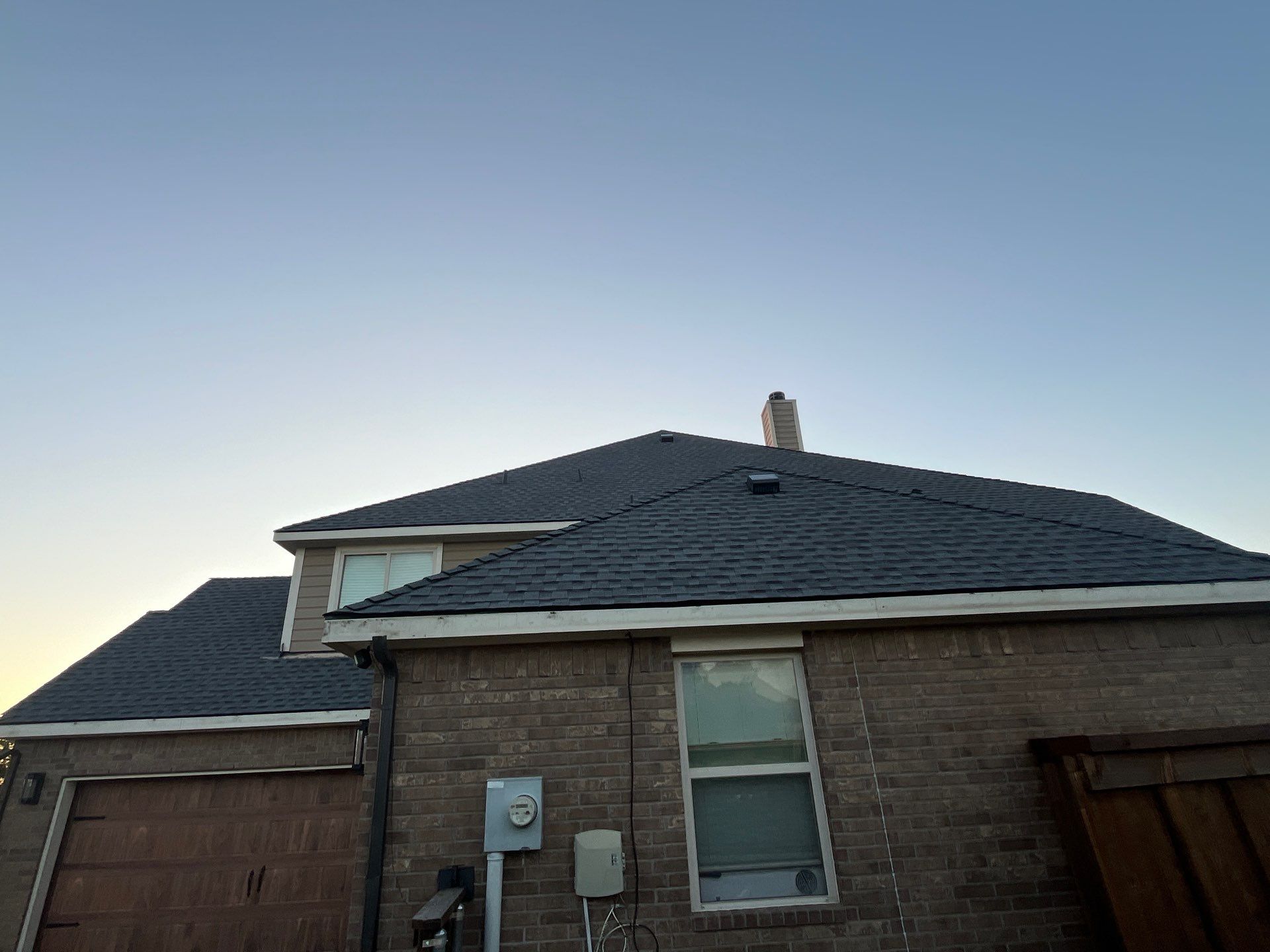 Medium brown brick with GAF Pewter Gray  by Tejas Roofworks + Restoration
